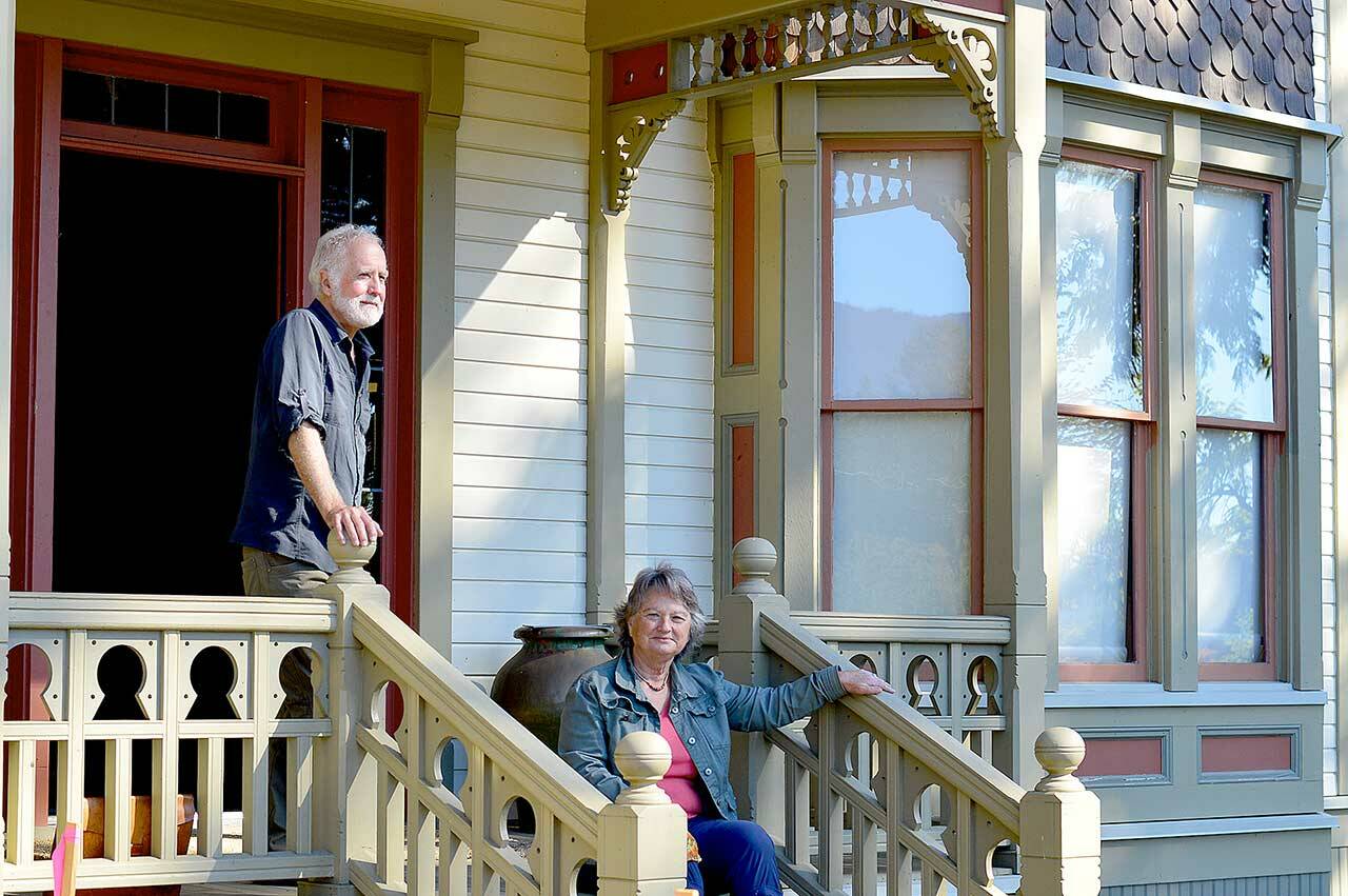 Oyster Races organizer Brian Cullin, left, and Quilcene Museum supporter Cleone Telling take in the sun on the porch of the 1892 Worthington Mansion in Quilcene. Sunday tours of the mansion are part of this weekend’s Quilcene Fair activities. (Diane Urbani de la Paz/Peninsula Daily News)