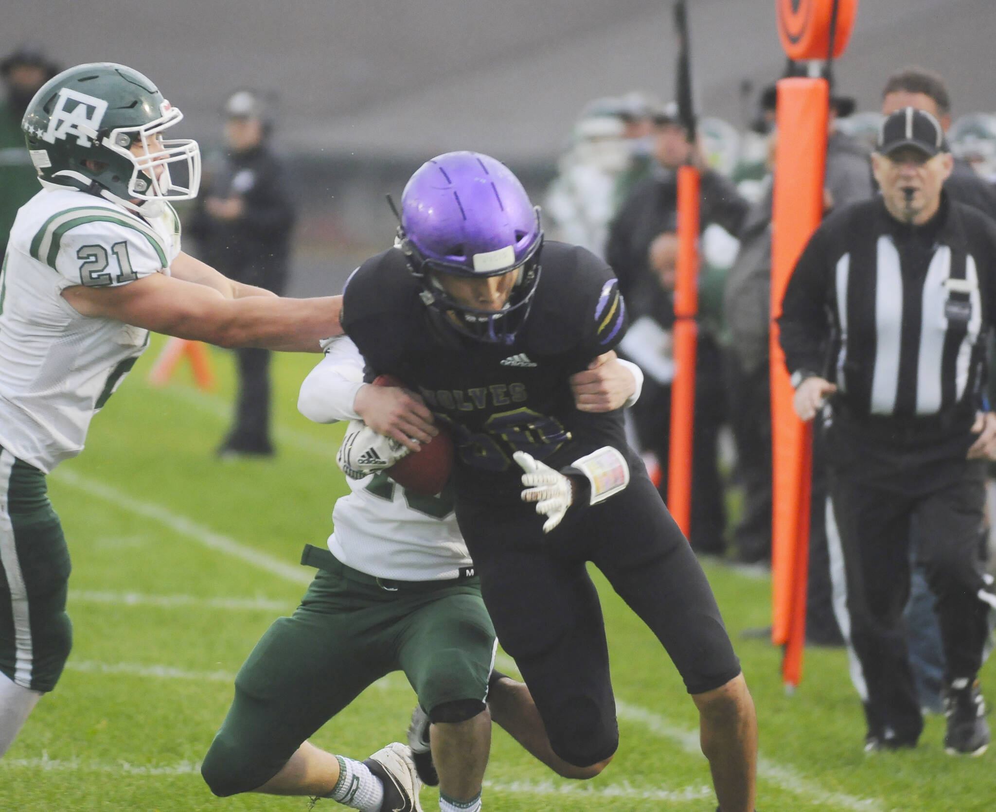 Michael Dashiell/Olympic Peninsula News Group
Sequim's Isaiah Moore adds run-after-catch yardage while Port Angeles' defenders including Daniel Cable, left, attempt to haul him down during Friday's Rainshadow Rumble rivalry game.