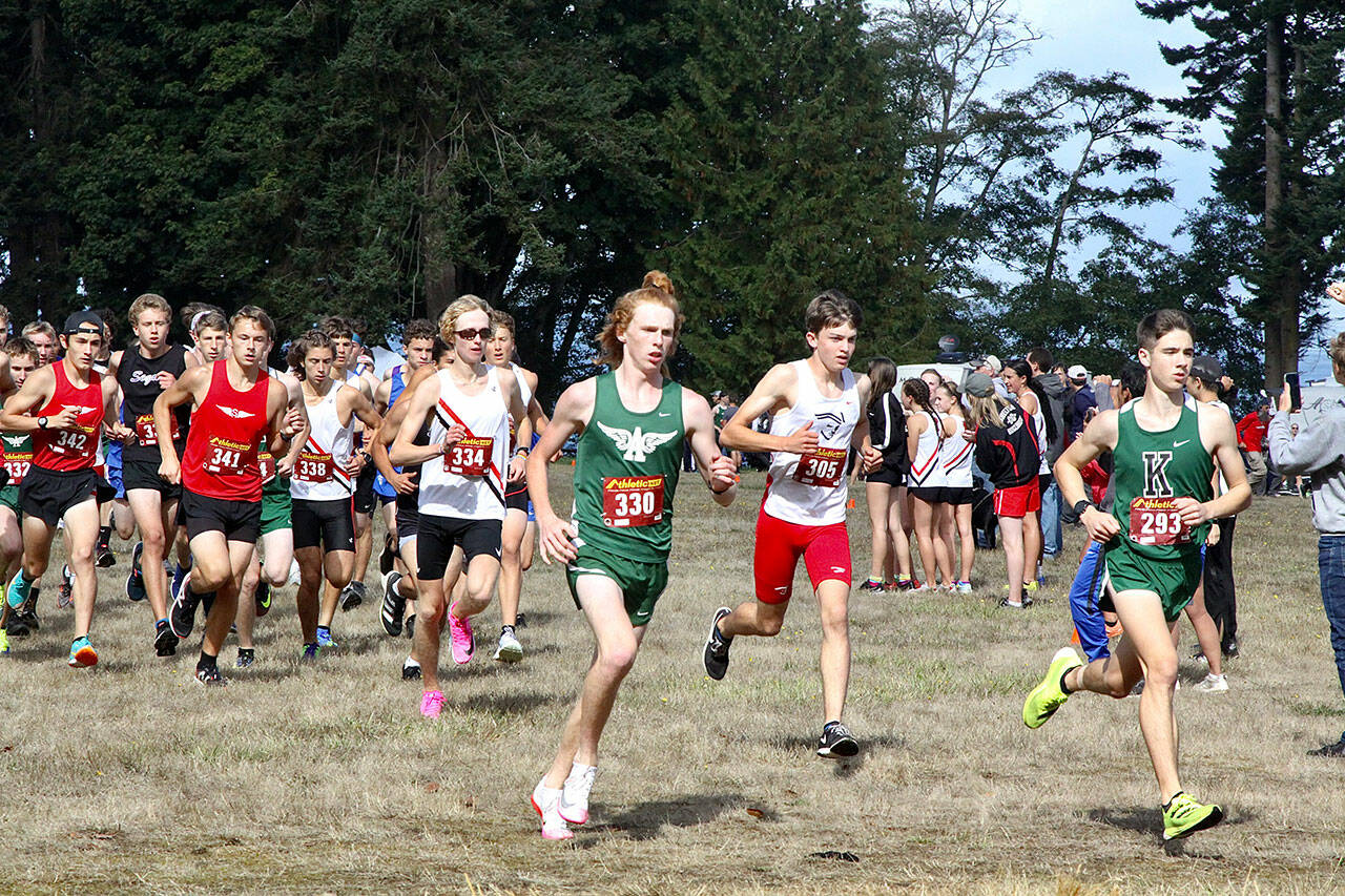 Port Angeles junior Jack Gladfelter, front left, races at the front of the pack at the opening of the varsity boys race at the 43rd Salt Creek Invitational at Salt Creek Recreation Area. Gladfelter finished second overall as the Roughrider boys claimed the varsity and junior varsity team titles. (Dave Logan/for Peninsula Daily News)