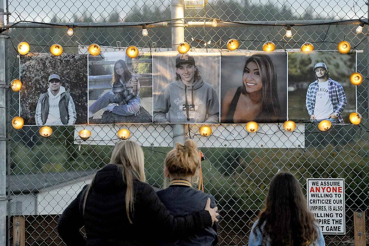 Mourners gathered Sunday night at Duncan Field in Forks for a candlelight vigil for Saturday morning crash victims, from left to right, Ariel Morales Sandoval, Gyovanna Morales, Jaden C. Lohrengel, Shaiyann A. Cummins and Tyler J. Ellis. Lohrengel, Ellis and Cummins died in the wreck. (Lonnie Archibald/For Peninsula Daily News)