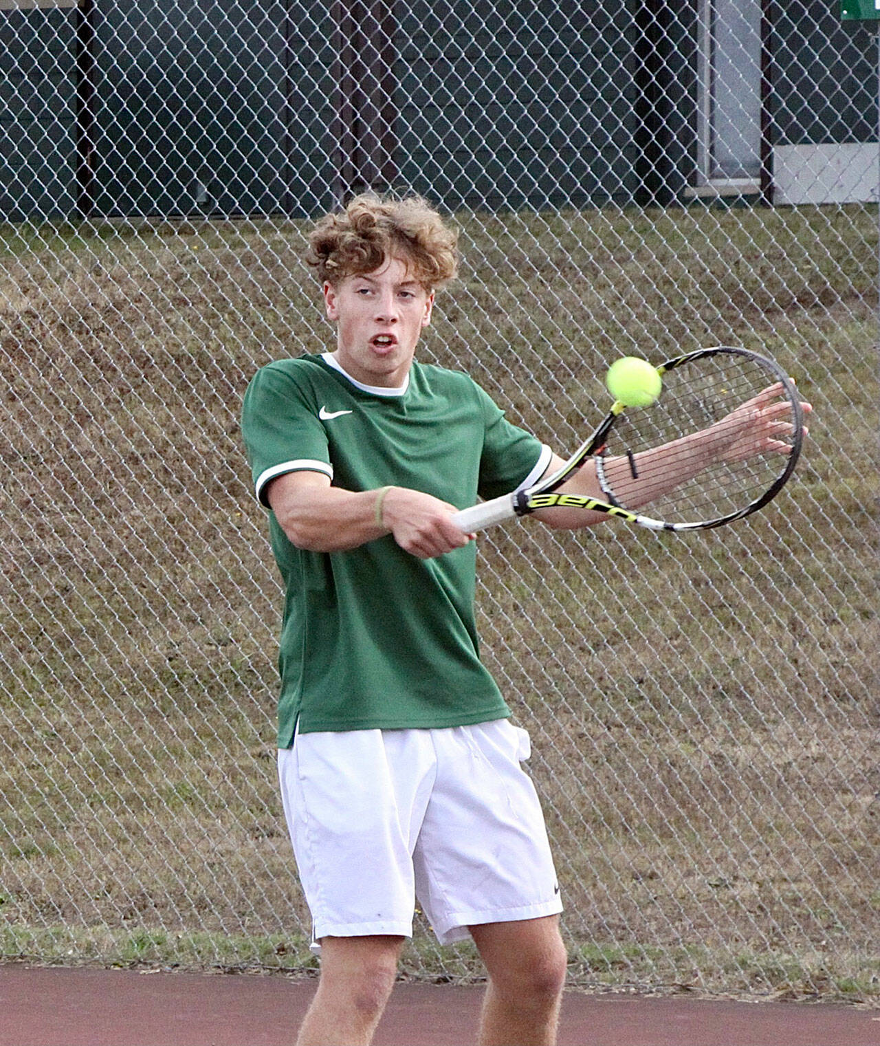 Port Angeles’ No. 1 boys tennis singles player Reef Gelder backhands a volley in the team’s match against North Kitsap on Monday. (Dave Logan/for Peninsula Daily News)