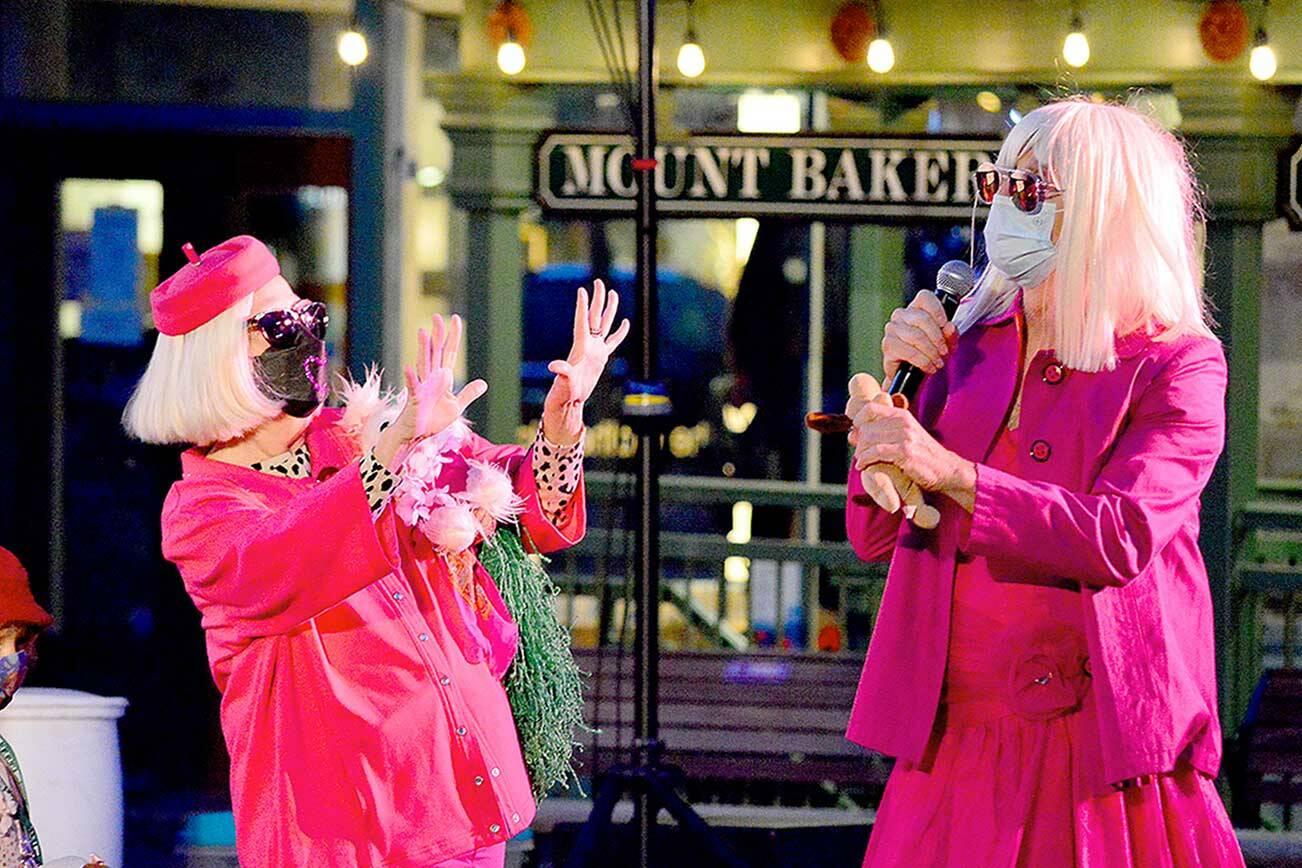 Port Townsend Film Festival Executive Director Janette Force, left, joins emcee Joey Pipia in dressing up for Saturday night’s outdoor screening of “Legally Blonde” in downtown Port Townsend. Force, who has led the organization for 12 years, is retiring after this fall’s festival. (Diane Urbani de la Paz/Peninsula Daily News)