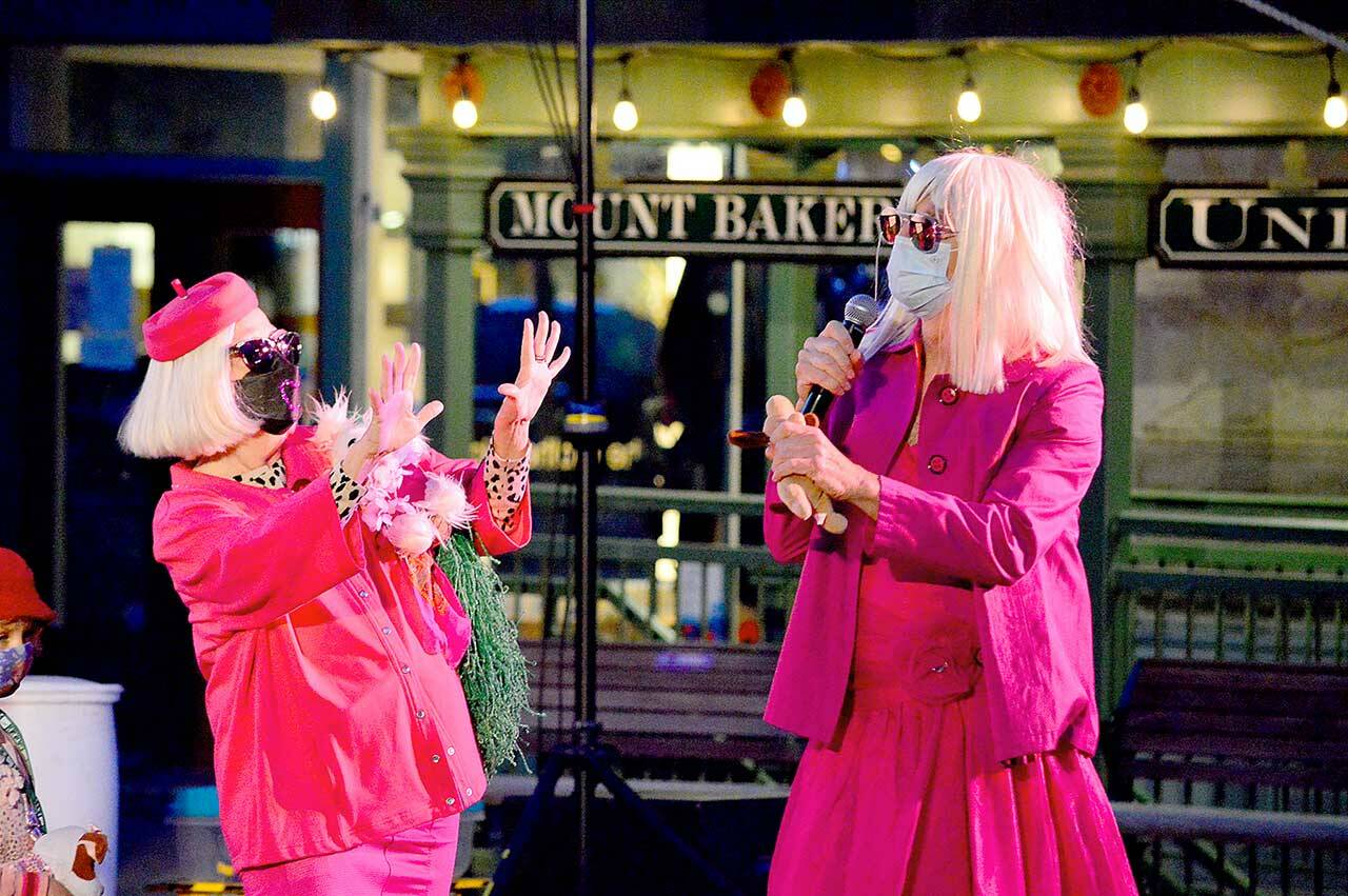 Port Townsend Film Festival Executive Director Janette Force, left, joins emcee Joey Pipia in dressing up for Saturday nights outdoor screening of Legally Blonde in downtown Port Townsend. Force, who has led the organization for 12 years, is retiring after this falls festival. (Diane Urbani de la Paz/Peninsula Daily News)