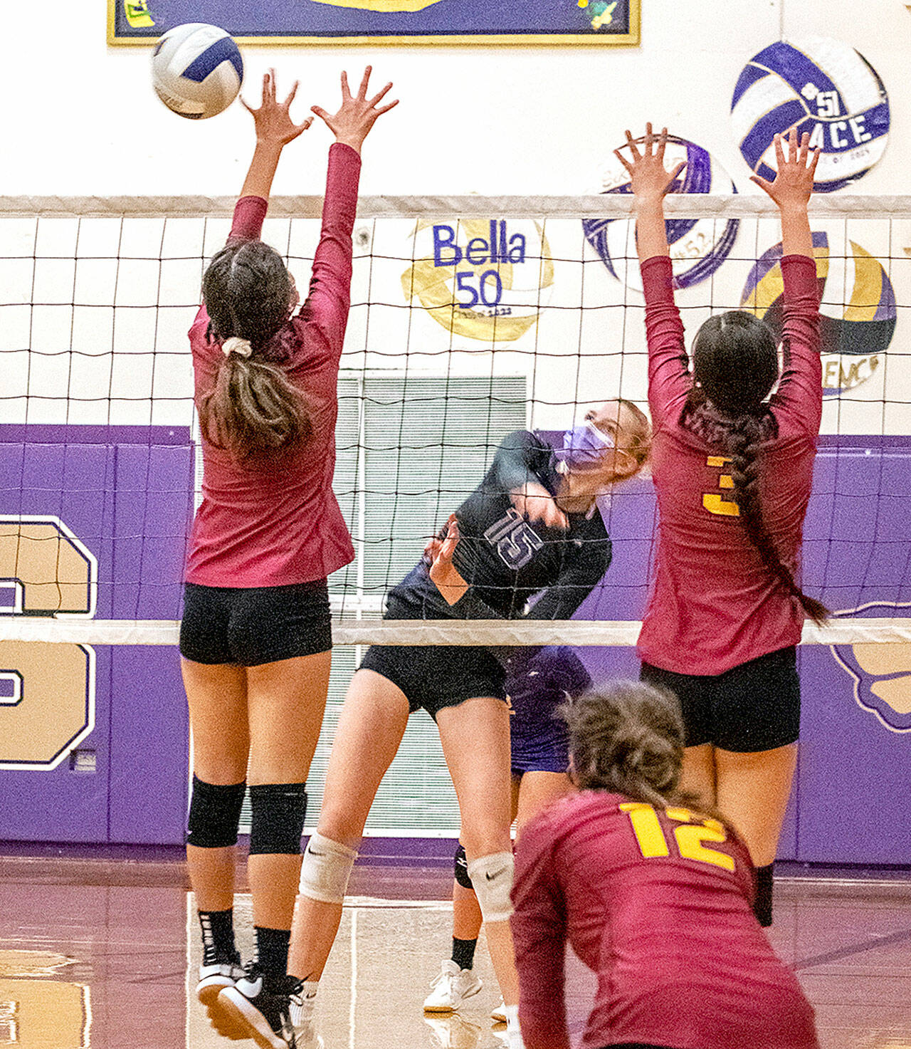 Sequim’s Kendall Hastings, center, hits past a couple of Kingston would-be blockers in a Olympic League 2A volleyball match Tuesday. The Wolves won 3-1, to improve to 4-2 in league play. (Emily Matthiessen/Olympic Peninsula News Group)