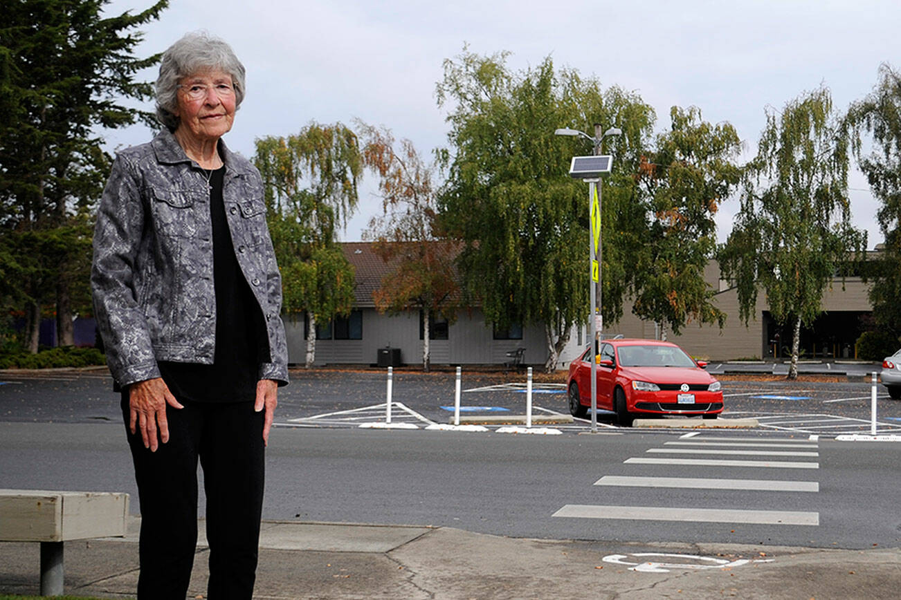 JoVonne Lingvall stands by a new pedestrian crosswalk at St. Joseph’s Catholic Church where she and her sister were struck by a vehicle last November. Lingvall survived, but her sister Lorraine (Reandeau) Anderson died four days later. (Matthew Nash/Olympic Peninsula News Group)