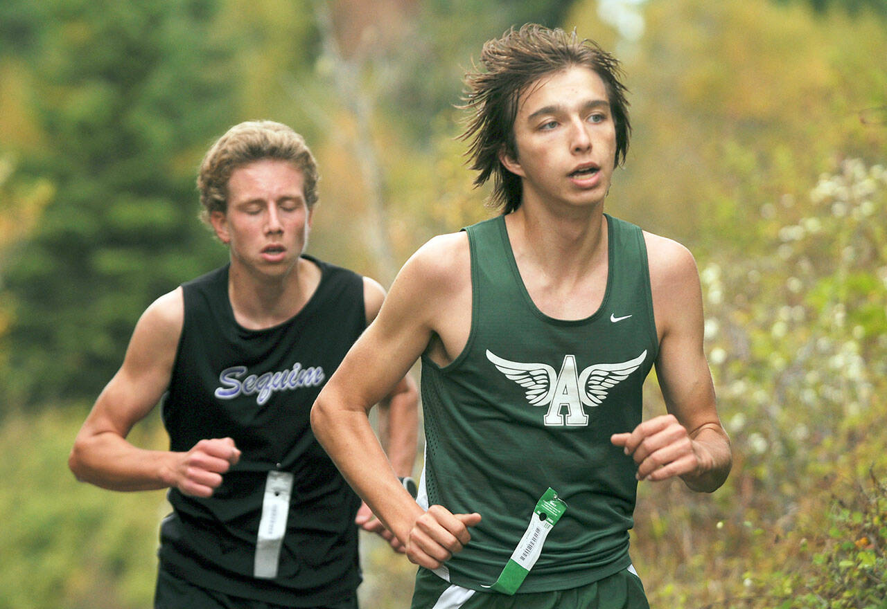Port Angeles’ Max Baeder, right, races with Sequim’s Colby Ellefson during a 3.1-mile Olympic League cross-country race at Voice of America at Dungeness Recreation Area. Ellefson ended up edging out Baeder for second place. (Michael Dashiell/Olympic Peninsula News Group)