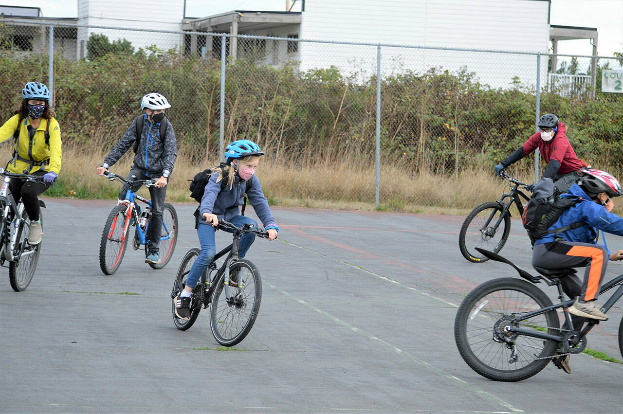 Starting from the left, volunteer instructor Linda Lenz, students Dustin Hines and Darby Berg, guest cyclist Dimitri Kuznetsov and student Max Galligan-Hong warm up for a ride at the Mountain Bike Club.  The club is part of ReCyclery's Jefferson County youth programs.  (Diane Urbani de la Paz / Peninsula Daily News)