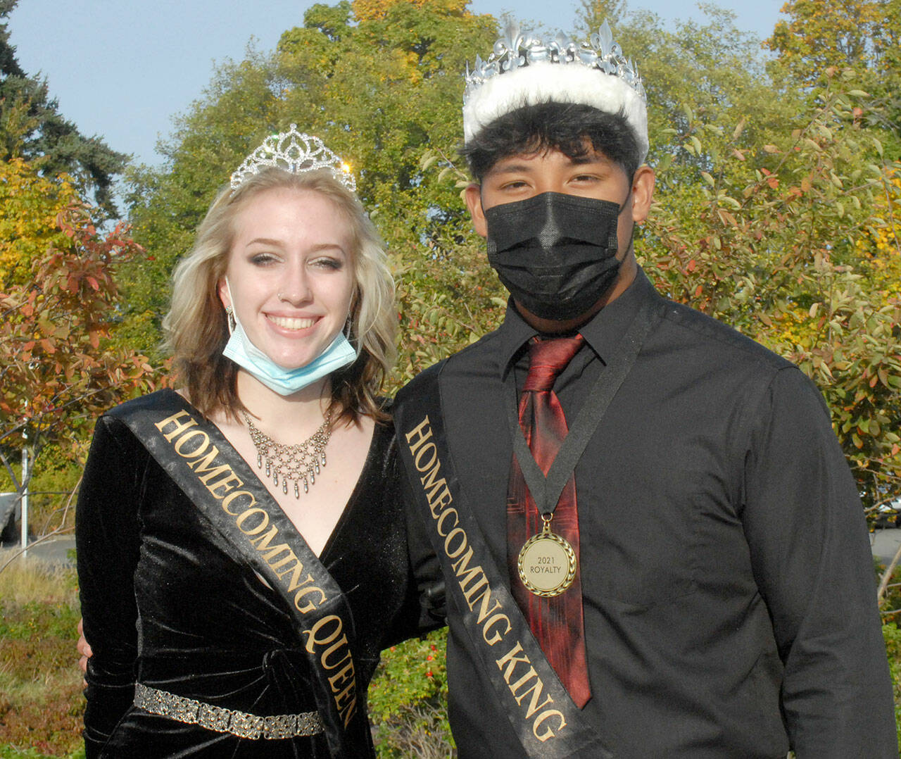 Port Angeles High School’s Samantha Robbins and Lance Menes stand together as homecoming senior queen and king before the school’s homecoming parade on Friday. The pair presided over festivities at the Roughriders’ football game on Friday night against the Kennedy Catholic Lancers. (Keith Thorpe/Peninsula Daily News)