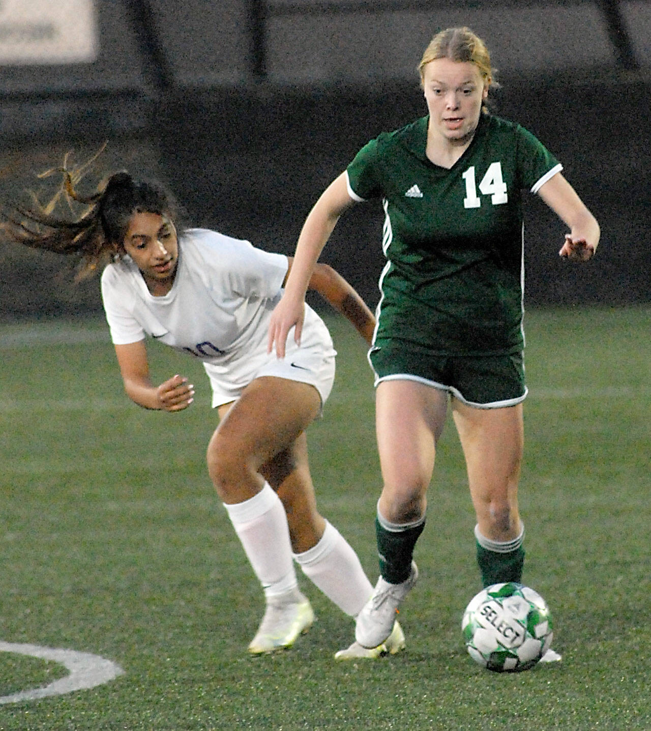 Port Angeles’ Anna Petty, right, pushes past Sequim’s Jennyfer Gomez on Tuesday at Peninsula College in Port Angeles. (Keith Thorpe/Peninsula Daily News)