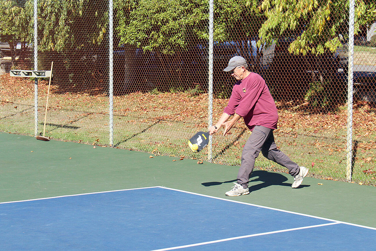 Tom Young serves to other members of the Port Townsend Pickleball Club during a game in the sun at the courts in front of the Jefferson County Courthouse on Wednesday afternoon. Temperatures are expected to cool off over the next few days. (Zach Jablonski/Peninsula Daily News)