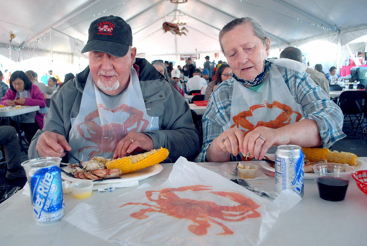 Larry and Kathi Hayden of Port Angeles enjoy crab dinners on Friday at the Dungeness Crab and Seafood Festival in Port Angeles. (Keith Thorpe/Peninsula Daily News)
