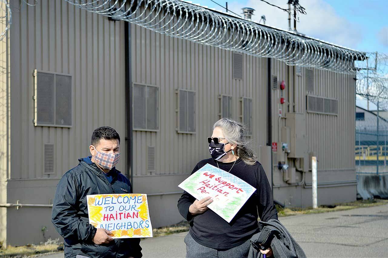 Manuel Abrego of Mountlake Terrace, left, stands beside Mary Givins of Port Angeles at the Northwest Detention Center in Tacoma on Sunday. Abrego was detained at the center for a year and a half. (Diane Urbani de la Paz/Peninsula Daily News)