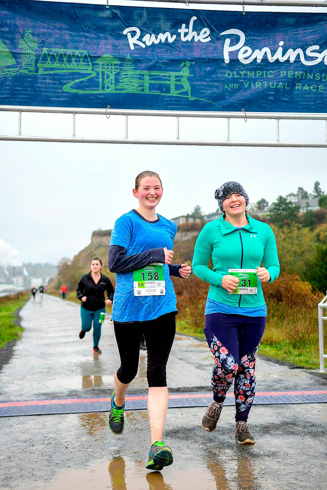 Elizabeth Hammel, left and Jessica Rohr, right cross the finish like at the Larry Scott Trail Run in 2019, the last year the event was run live.