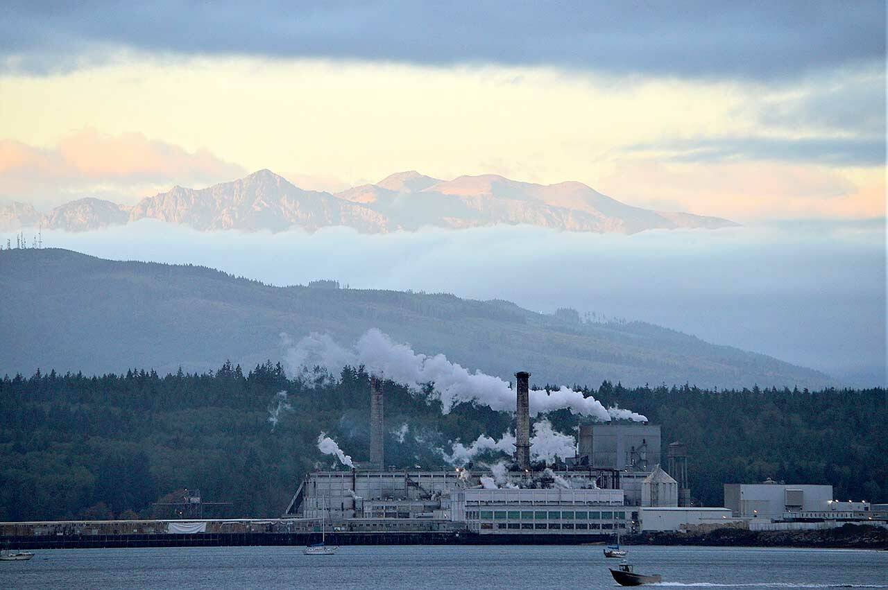 Soon after dawn, clouds part to reveal the Olympic Mountains high above the Port Townsend Paper mill from the Washington State Ferry dock in Port Townsend. Sunrise will come about 90 seconds later each morning through the solstice on Dec. 21. (Diane Urbani de la Paz/Peninsula Daily News)