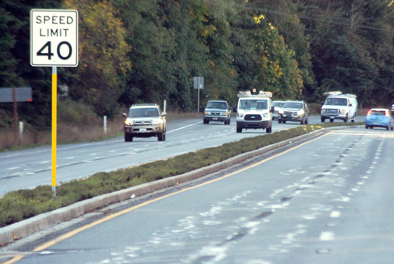 Traffic on U.S. Highway 101 at Morse Creek east of Port Angeles travels on Wednesday next to recently-planted, dought-resistant shrubs in the traffic median. (Keith Thorpe/Peninsula Daily News)