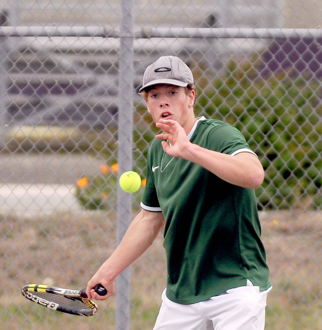 Group Port Angeles’ Reef Gelder returns a volley during his No. 1 singles match with Sequim’s Garrett Little on Thursday. Little and the Wolves won the match 4-3. (Michael Dashiell/Olympic Peninsula News)