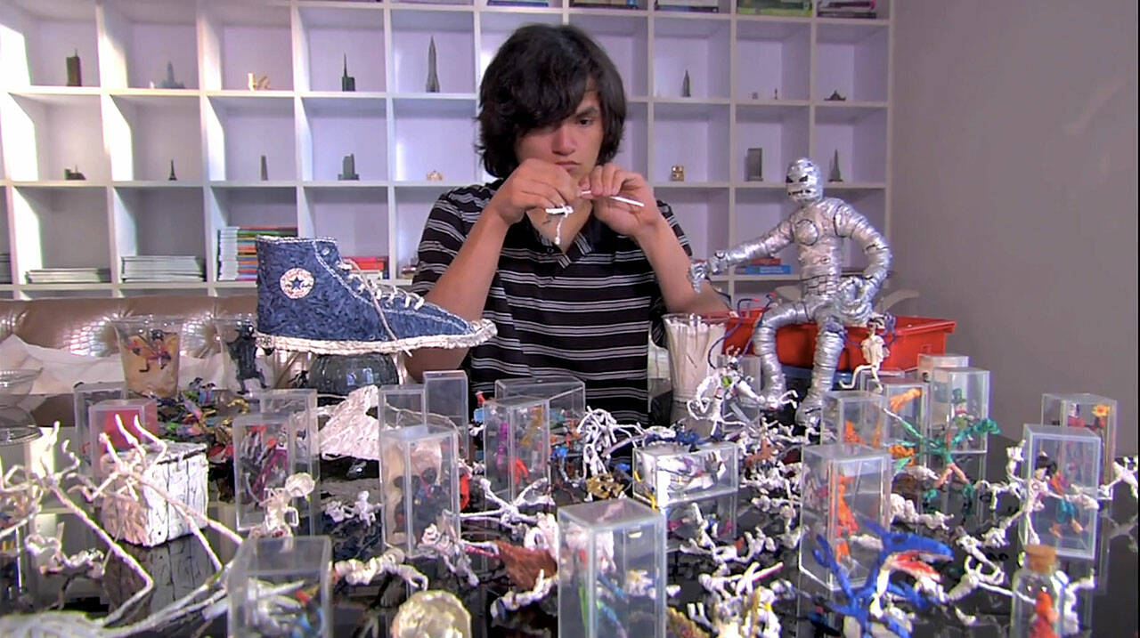 Brian Tolley works surrounded by his art created from twist-ties in Mr. Twister, a film about a teen with autism who wanted to combat how people were treating him differently from others. Screenshot courtesy of Sproutflix