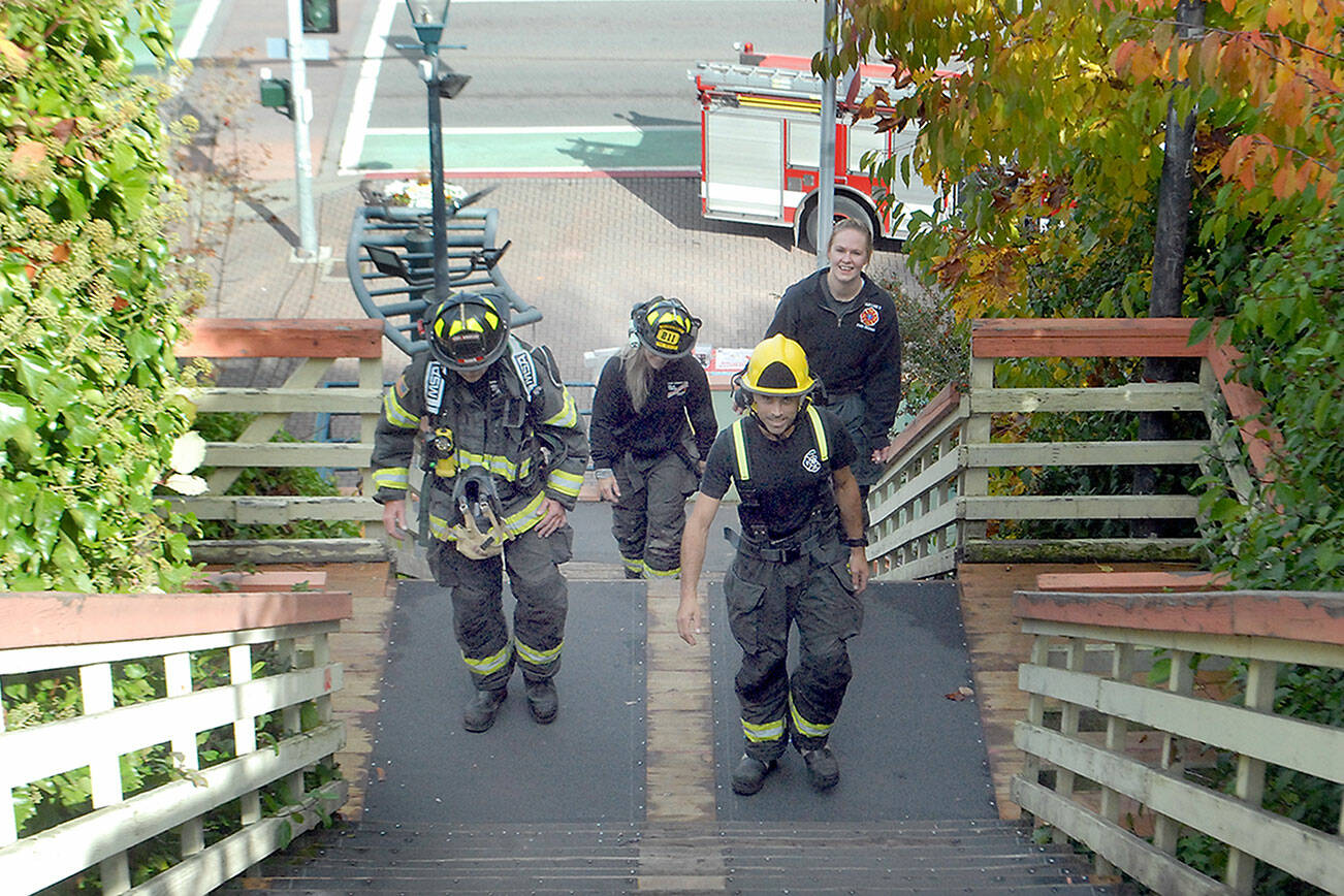 Stairclimbers, from left, Tim Davis, Margie Brueckner, Matt Aston and Esther McKellar of the Port Angeles Fire Department, practice ascending the Laurel Street Stairs above downtown Port Angeles on Saturday in preparation for next spring’s 31st annual LLS Firefighter Stairclimb on March 13 at the Columbia Center in downtown Seattle. The climb, a benefit for the Leukemia & Lymphoma Society, requires firefighters and emergency personnel to make a timed ascent of the 788-foot skyscraper’s 69 flights of stairs to help fund cancer research. (Keith Thorpe/Peninsula Daily News)