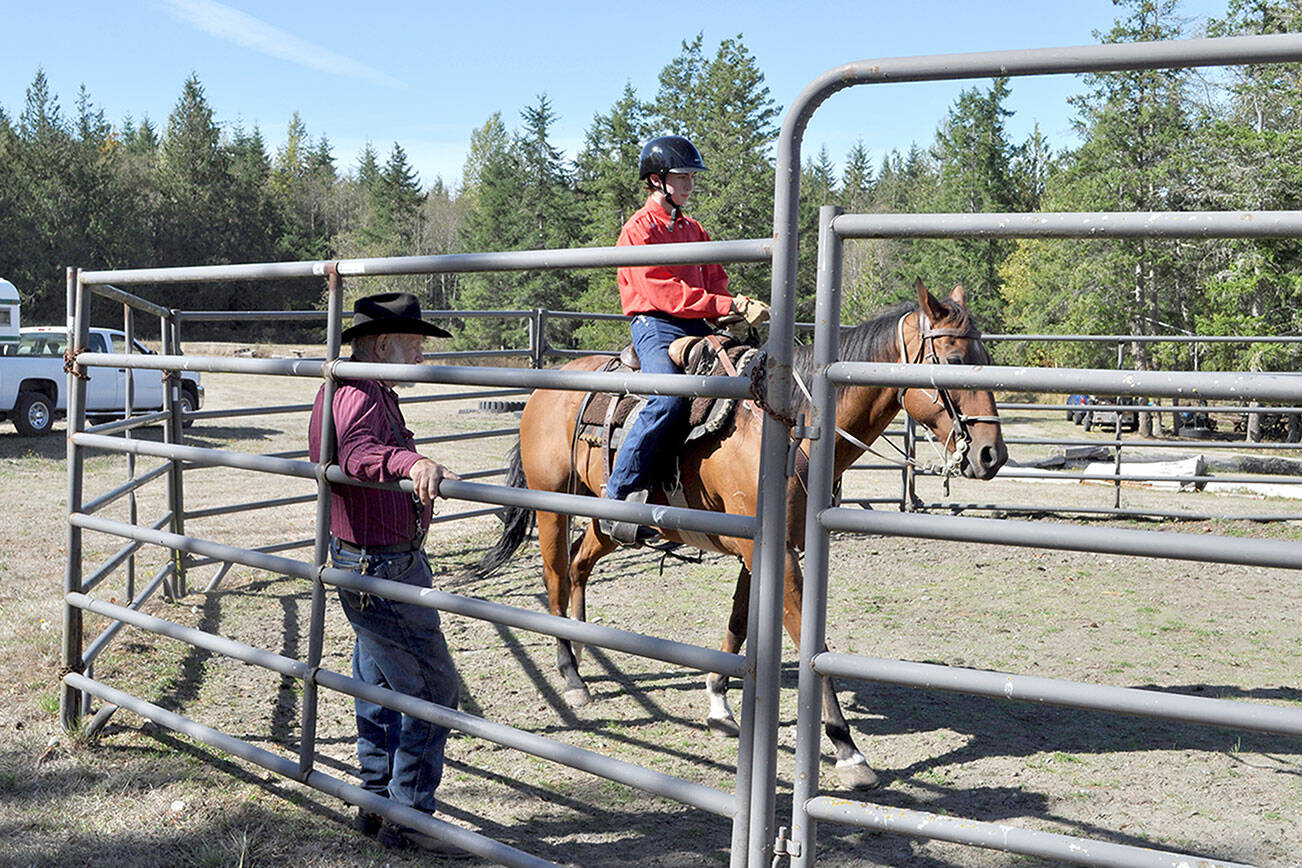Back Country Horsemen of Washington Peninsula Chapter member Del Sage helps a Scout with Troop 1498 with his horse-riding skills at Layton Hill Horse Camp. (Courtesy of Linda Morin)