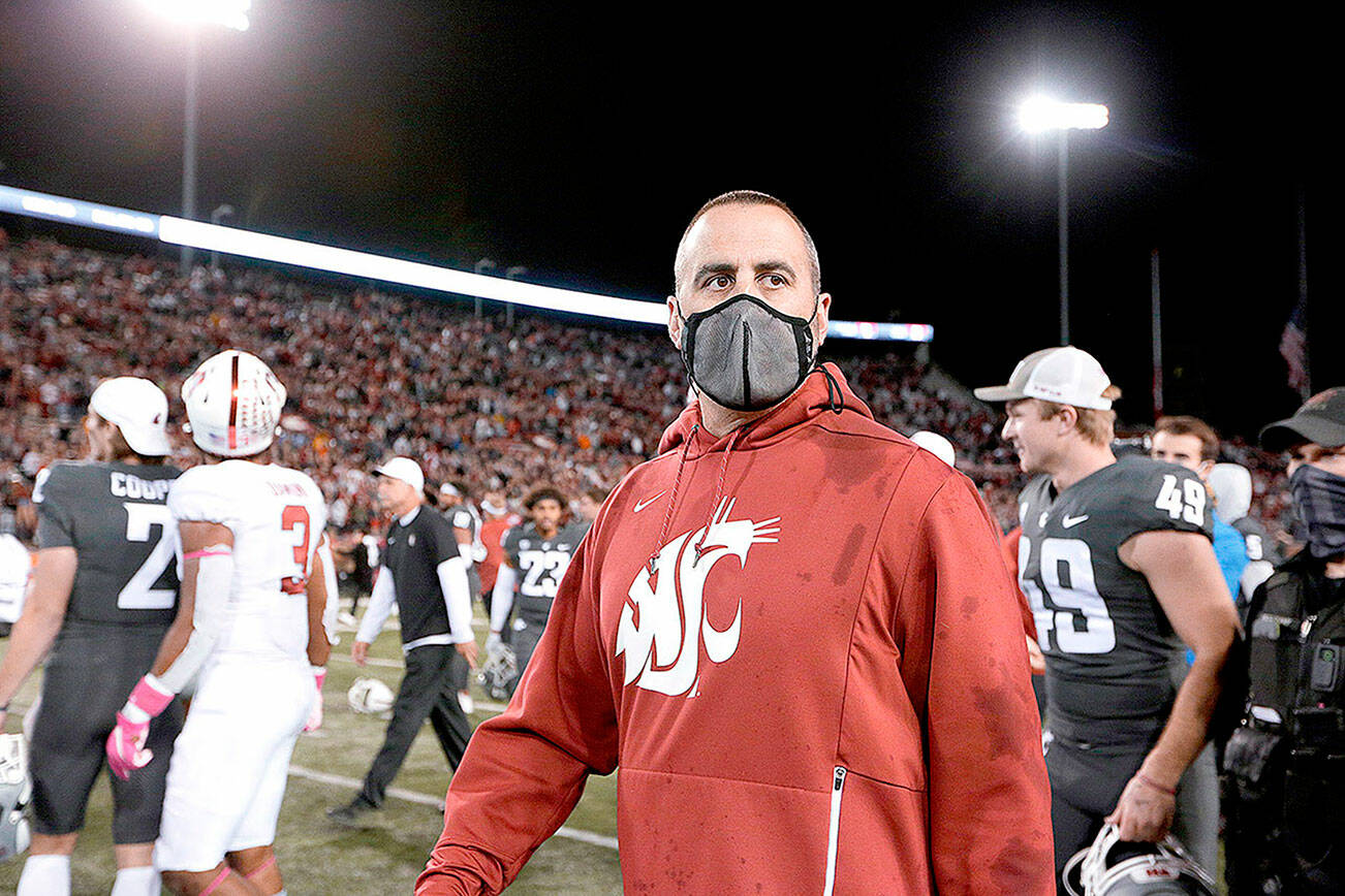 Washington State coach Nick Rolovich walks on the field after the team's NCAA college football game against Stanford, Saturday, Oct. 16, 2021, in Pullman, Wash. Washington State won 34-31. (AP Photo/Young Kwak)