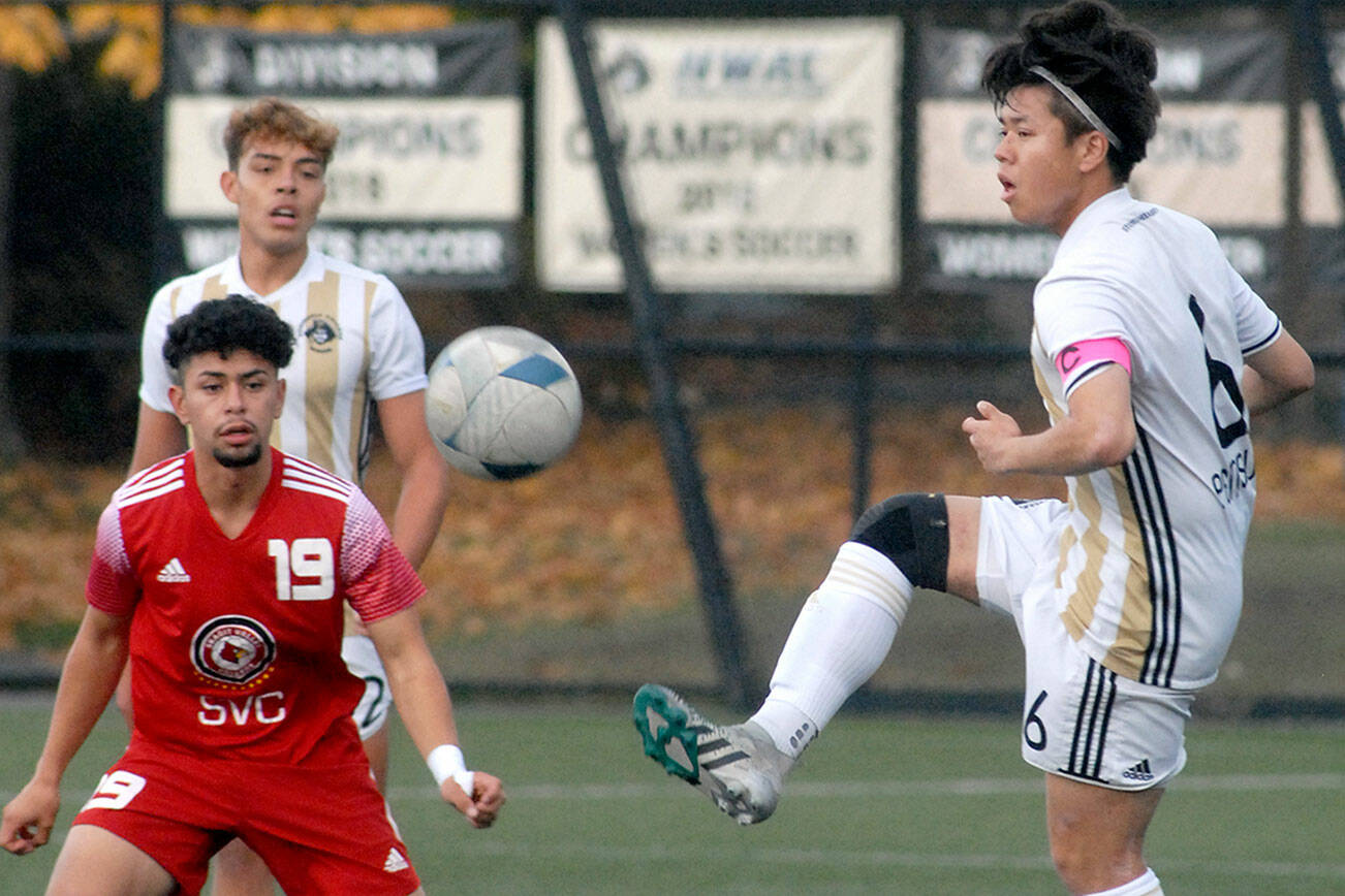 Keith Thorpe/Peninsula Daily News
Peninsula's Jeong Hyun Kang, right, gets in a high kick as Skagit Valley's Sergio Garduno Mendez, left, and teammate Christopher Dominguez look on during Wednesday's match in Port Angeles.