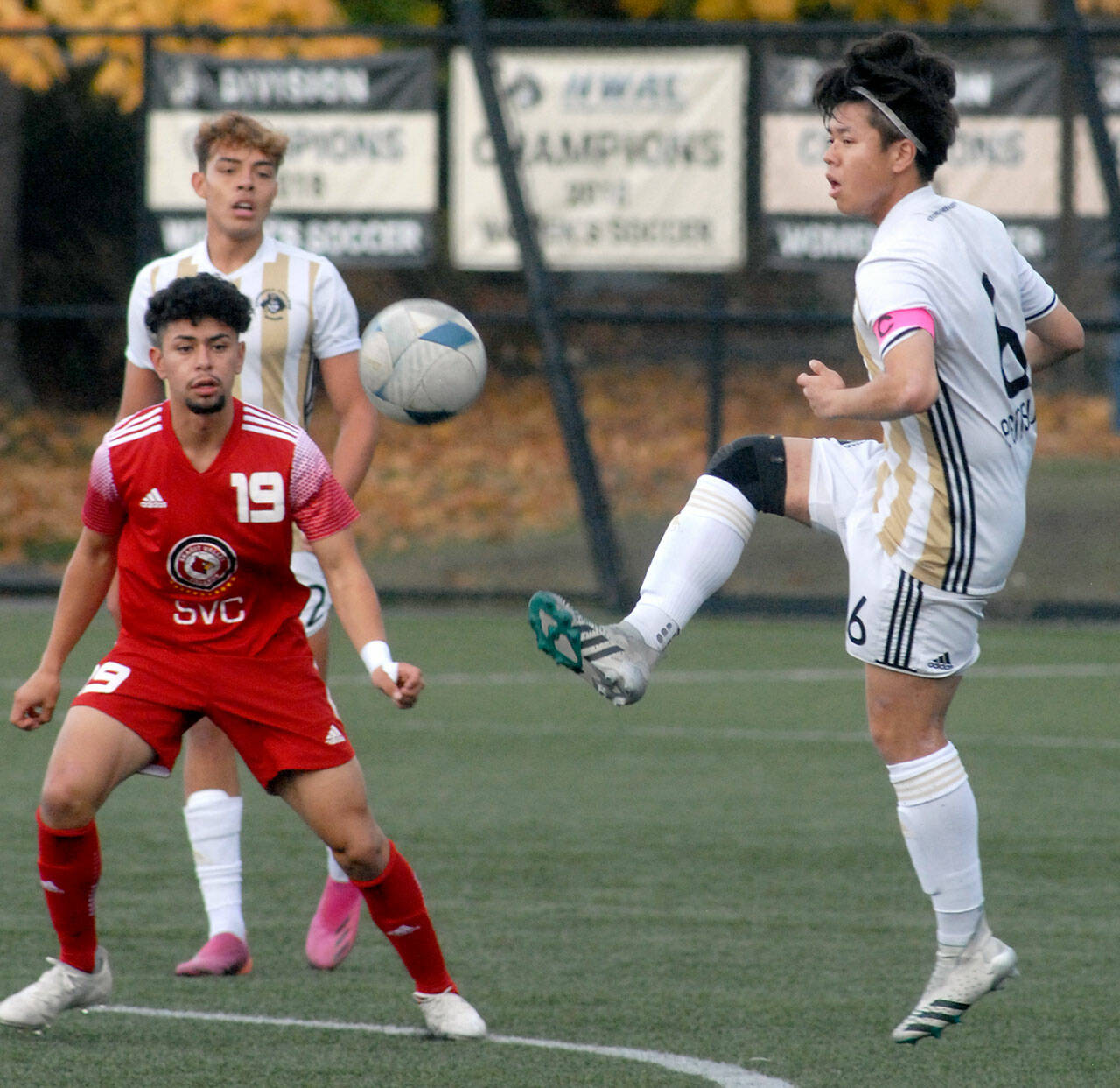 Peninsula’s Jeong Hyun Kang, right, gets in a high kick as Skagit Valley’s Sergio Garduno Mendez, left, and teammate Christopher Dominguez look on during Wednesday’s match in Port Angeles. (Keith Thorpe/Peninsula Daily News)
