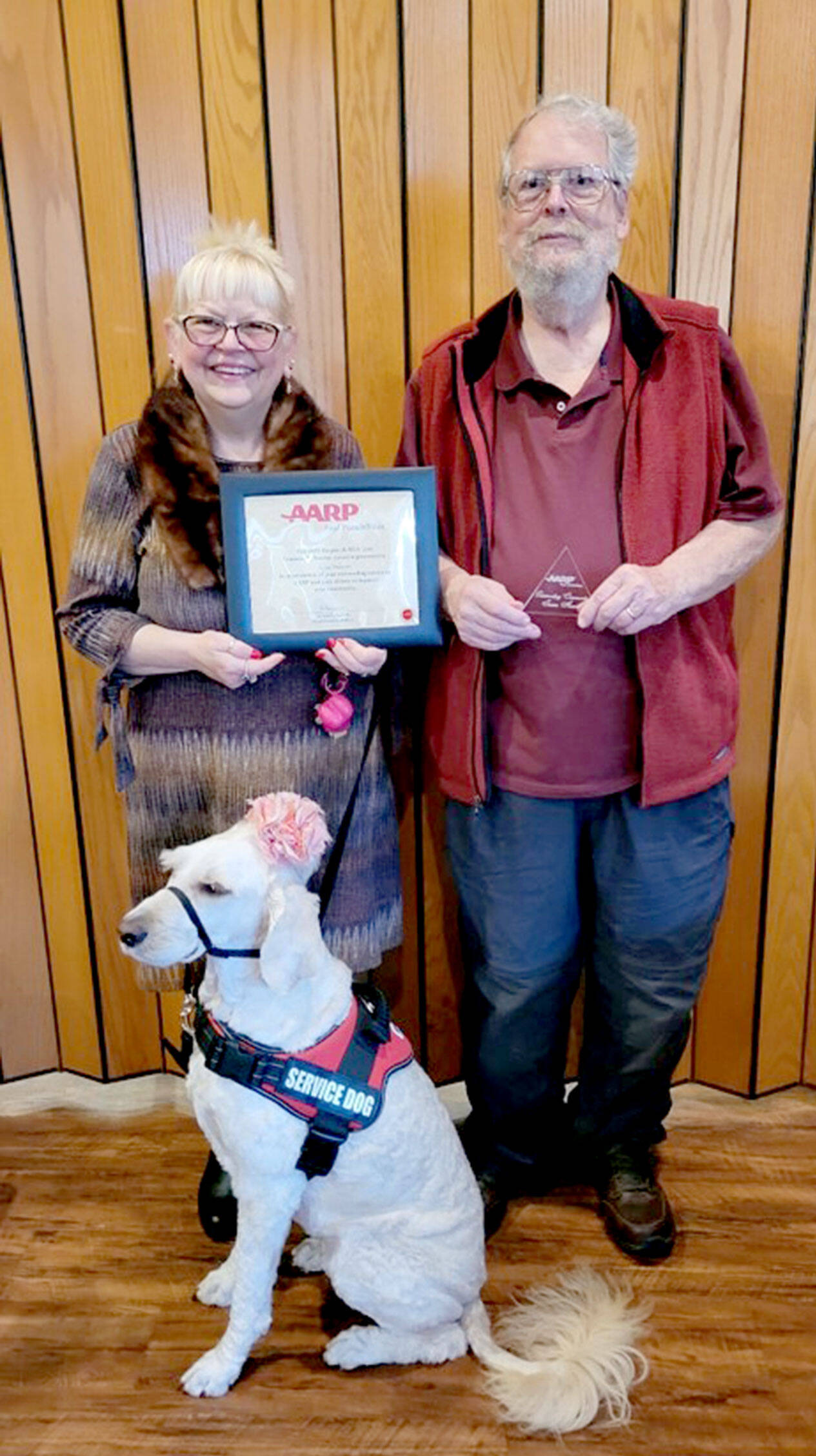 Lora Brabant, on left, and Gary Gleason along with Daisy, Brabant’s service dog.