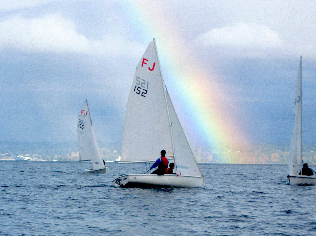 Port Angeles High School sailing team members Elliot Dahlin and Fern Knobel (152), sail at a regional scrimmage this weekend off Kingston as a rainbow comes out. Teammates Ozzy Minard and Ella Schulz are in boat 156. (Photo courtesy Perry Brestel)