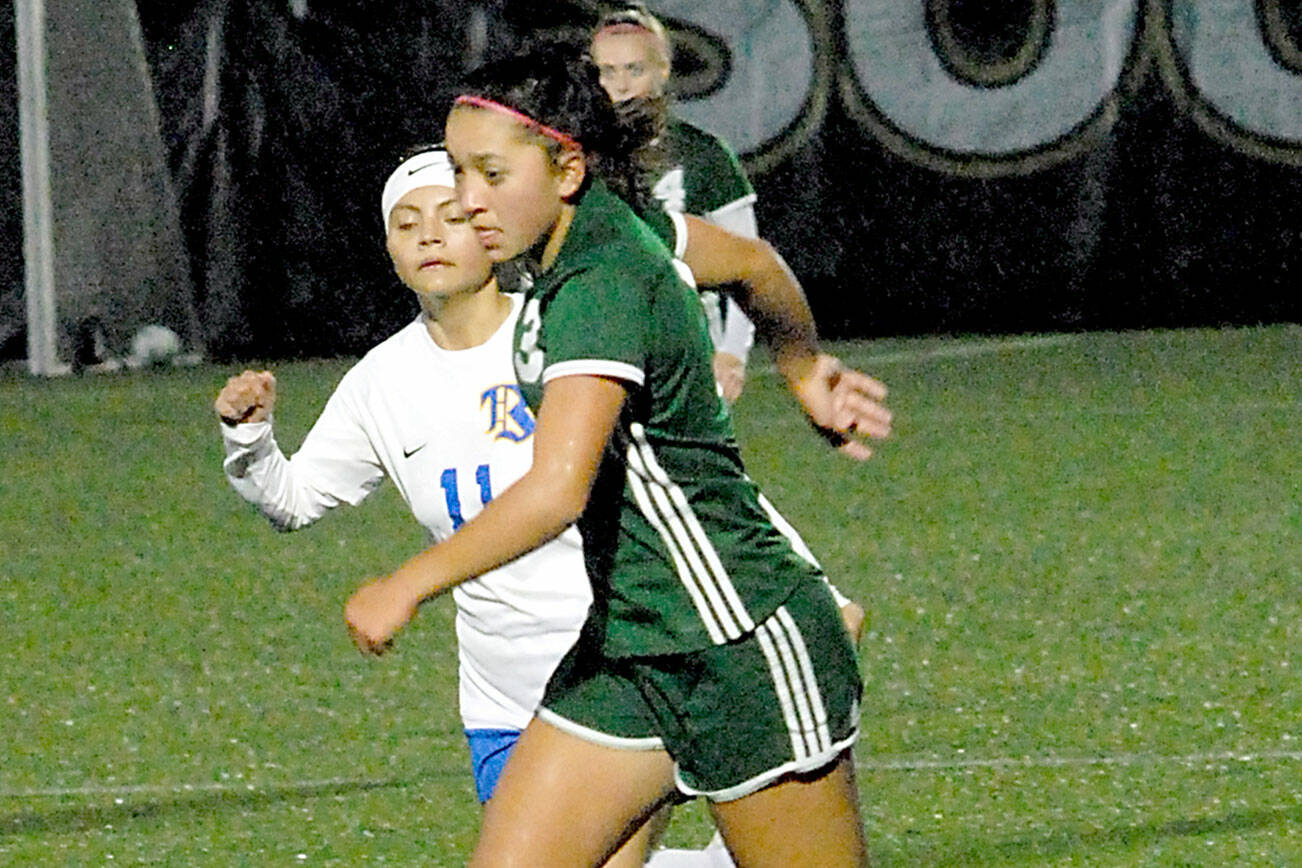 Keith Thorpe/Peninsula Daily News
Port Angeles' Lily Sanders, right, slips past Bremerton's Marisol Popoca-Pablo on Thursday night in Port Angeles.