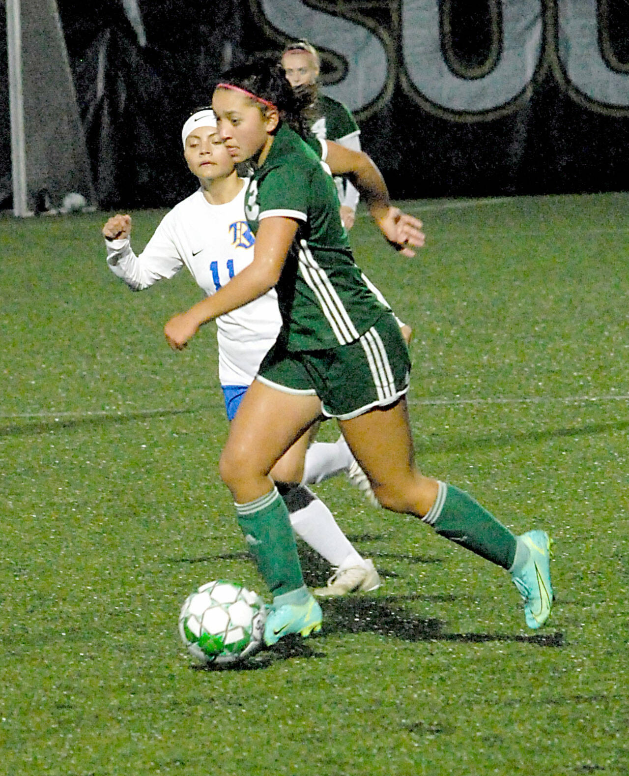 Keith Thorpe/Peninsula Daily News Port Angeles’ Lily Sanders, right, slips past Bremerton’s Marisol Popoca-Pablo on Thursday night in Port Angeles.