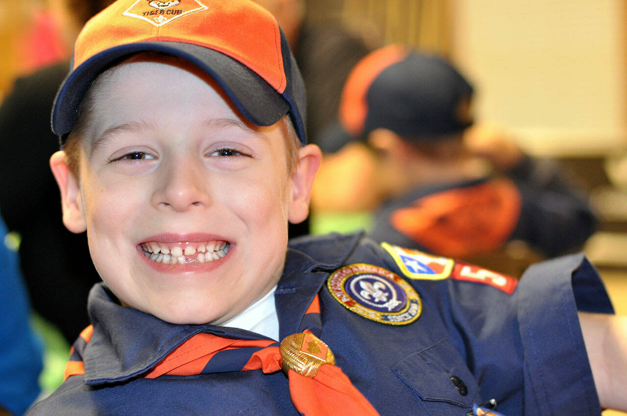 Emerson Ake smiles in his cub scout uniform in Sequim. Ake and his family have temporarily moved to Bellevue as he battles leukemia at the Seattle Children’s Hospital. (Ake family)