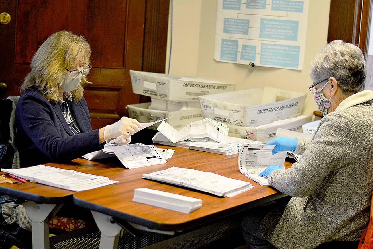 Jefferson County seasonal elections staffers Dale Meyer, left, and Betty Grewell open hundreds of ballots Monday afternoon at the Jefferson County Courthouse in Port Townsend. More than 33 percent — 33.88 percent — of the 27,582 ballots mailed to registered voters had been returned as of Monday, according to the Jefferson County elections office. Of the 9,344 ballots returned, 137 had been challenged for problems with the signatures or other reasons. Ballots must be postmarked by today or deposited at one of seven drop boxes in the county tonight by 8 p.m. Initial results will be posted at www.peninsuladailynews.com. Look for more coverage in Thursday’s print editions. (Diane Urbani de la Paz/Peninsula Daily News)
