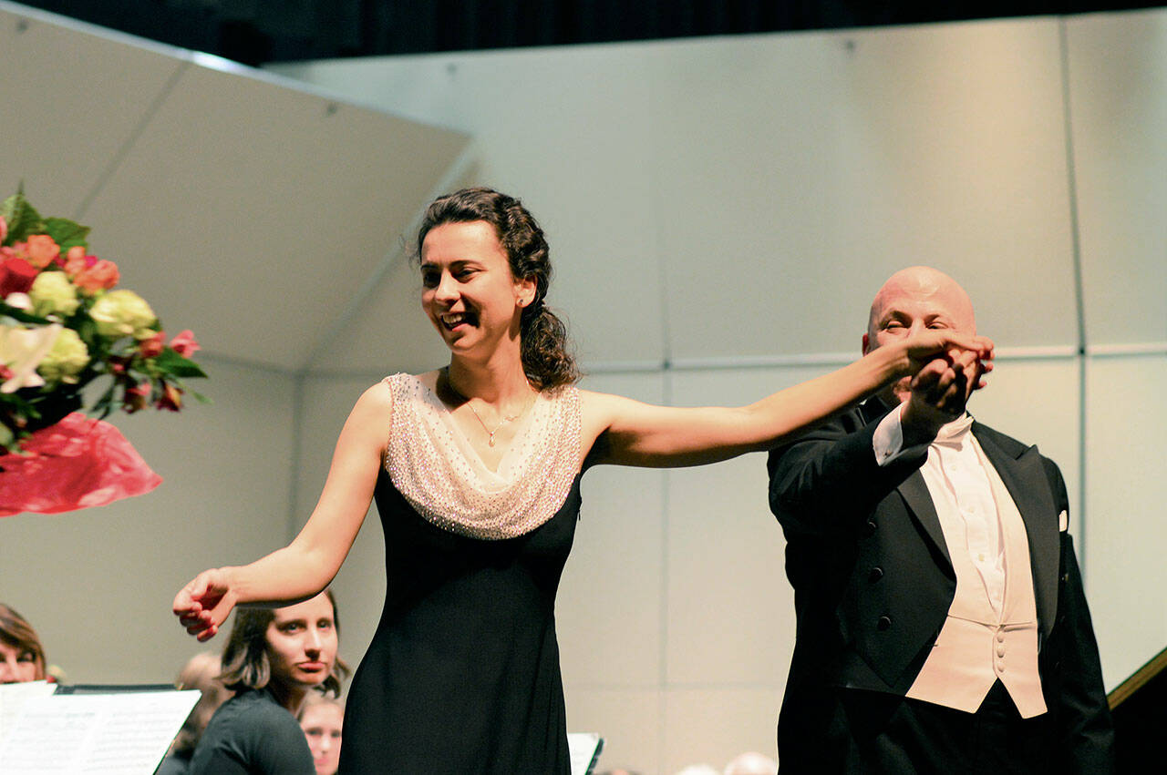 Piano soloist Anna Petrova accepts the first bouquet after her 2017 performance with the Port Angeles Symphony conducted by Jonathan Pasternack, right. Petrova, Pasternack and the orchestra will reunite for two concerts this Saturday at the Port Angeles High School Performing Arts Center. (Diane Urbani de la Paz/Peninsula Daily News)