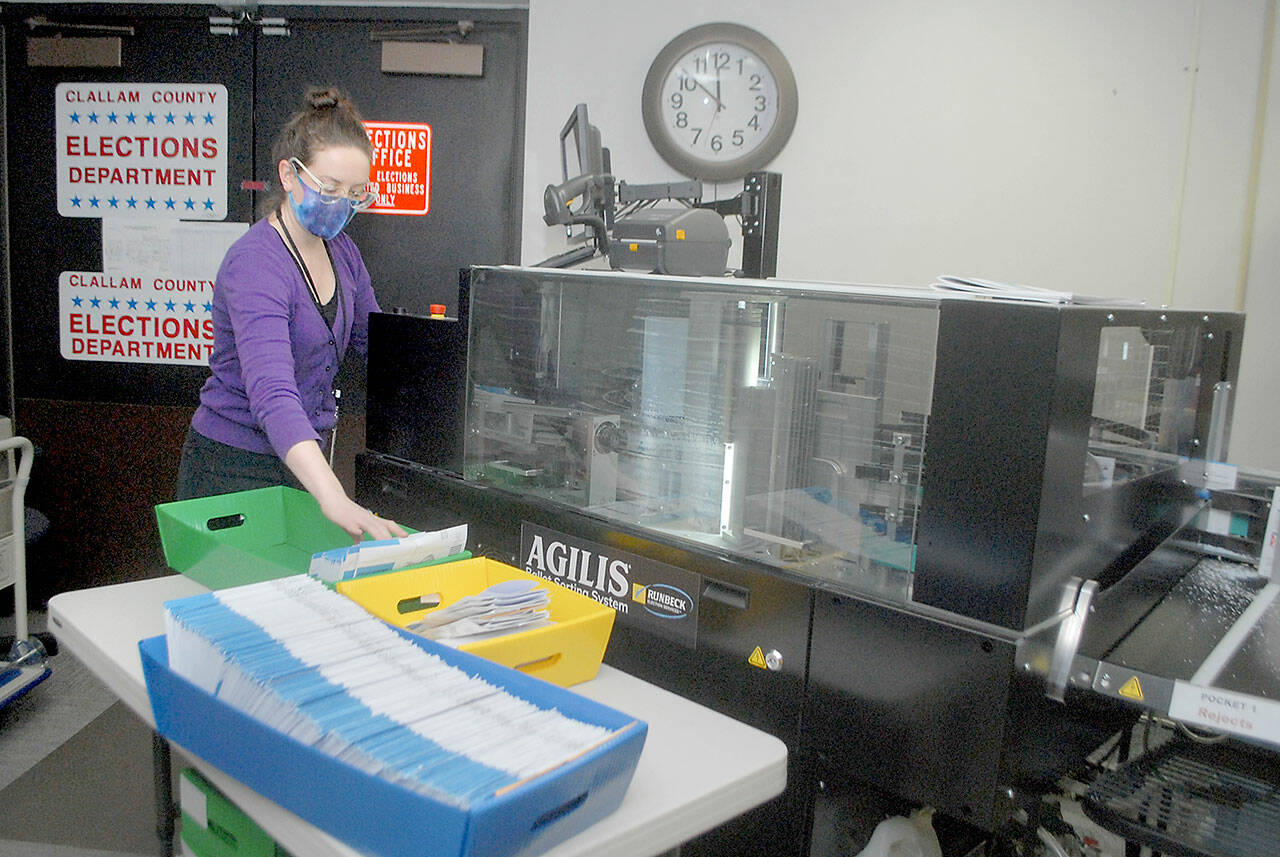 Clallam County elections official Nicole Mischke prepares ballots to run through a sorting machine on Tuesday at the Clallam County Courthouse in Port Angeles. (Keith Thorpe/Peninsula Daily News)