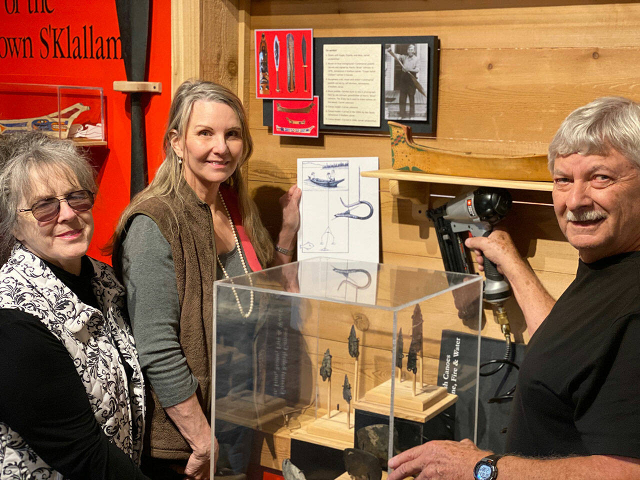Sequim Museum Director Judy Stipe, left, and volunteers Bob Stipe, exhibit woodworker, and Katherine Vollenweider, volunteer designer and curator, put the finishing touches on the new exhibit, Journey Through Time, opening this week at the Sequim Museum & Arts, 544 N. Sequim Ave. Submitted photo