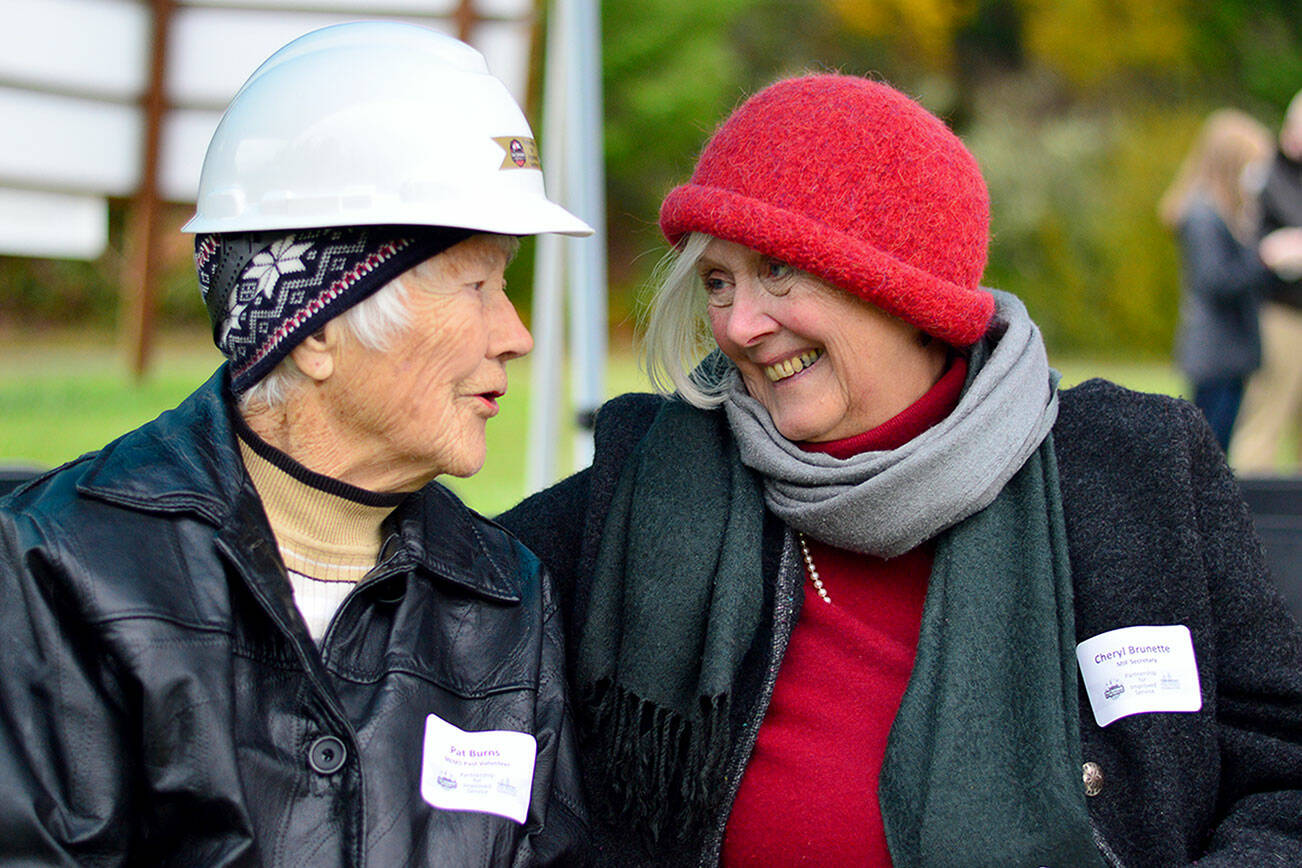 Pat Burns, left, at 102 the oldest member of the Marrowstone Island emergency response community, and her friend, Cheryl Brunette, attend the groundbreaking Thursday for the island’s new fire station. (Diane Urbani de la Paz/Peninsula Daily News)