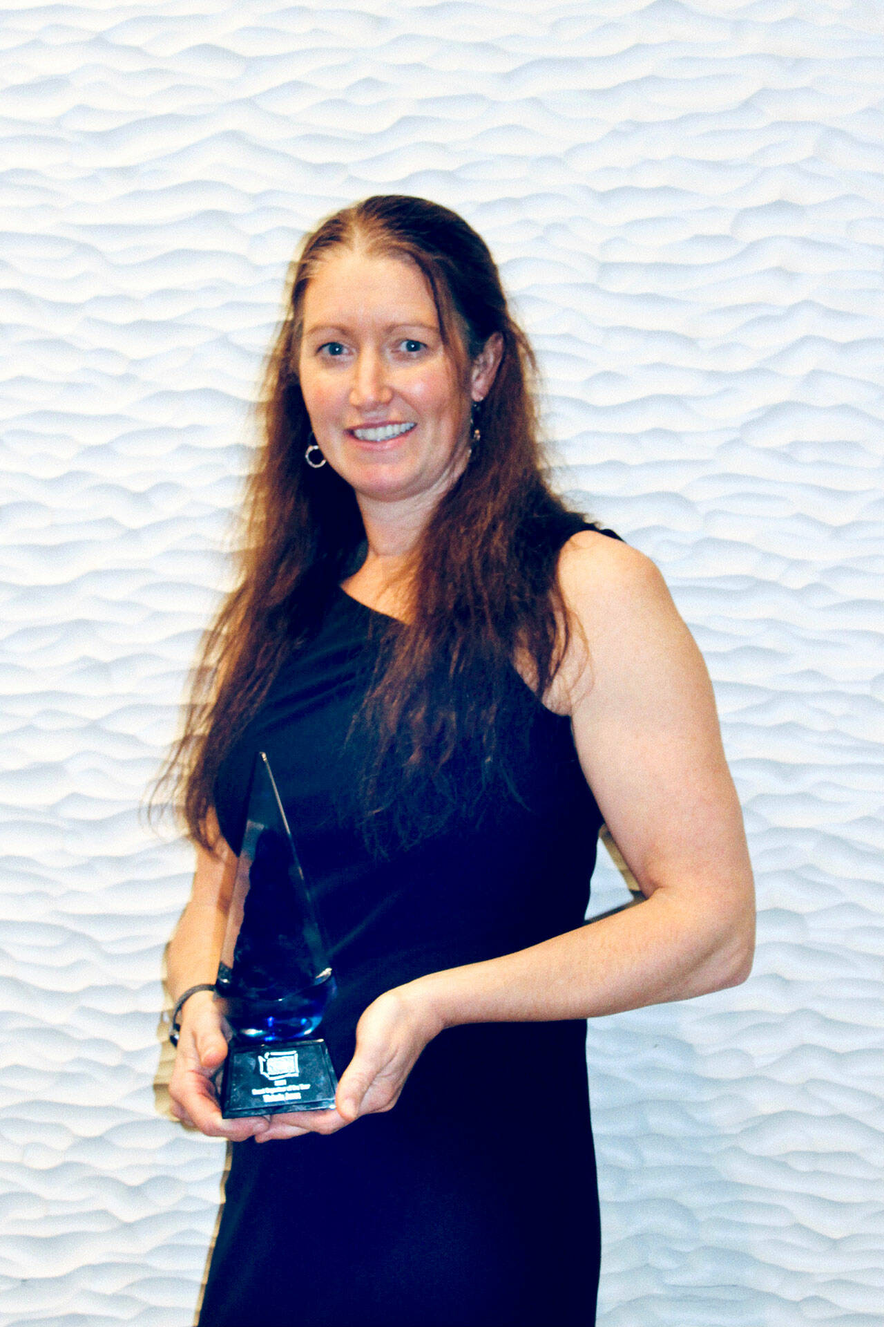 Victoria Jones, race director of the Port Angeles Marathon Association, displays the 2021 Washington State Event Organizer of the year award she was given by the Washington Festivals & Events Association.