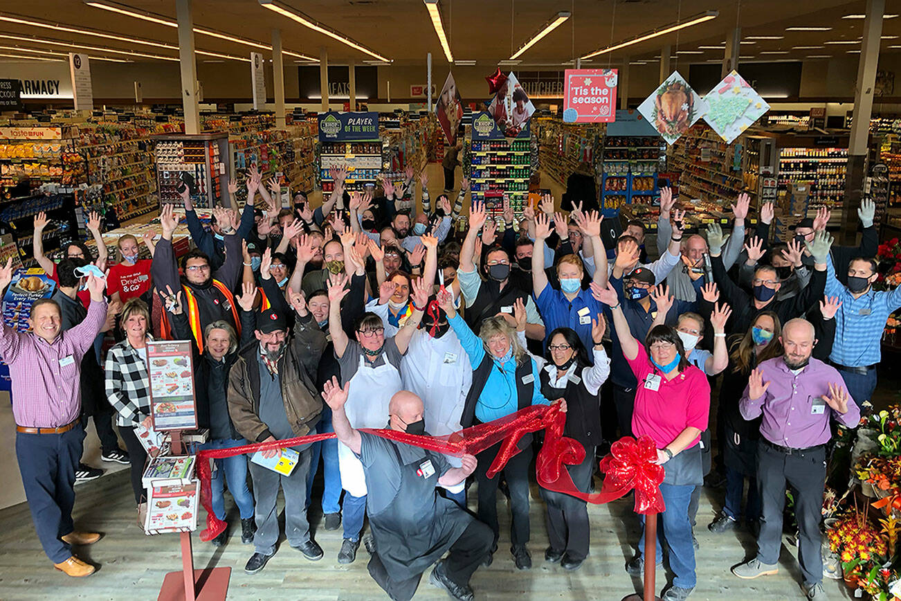 Sequim Safeway employees gather for a ribbon cutting at the "Grand Reopening" of the store at 680-F W. Washington St., on Oct. 27. The store began an extensive remodel on July 5 and finished Oct. 19, store director Joe Barton said. Itg was the first remodel since 2004, staff said. Photo courtesy of Isaac Peiffer