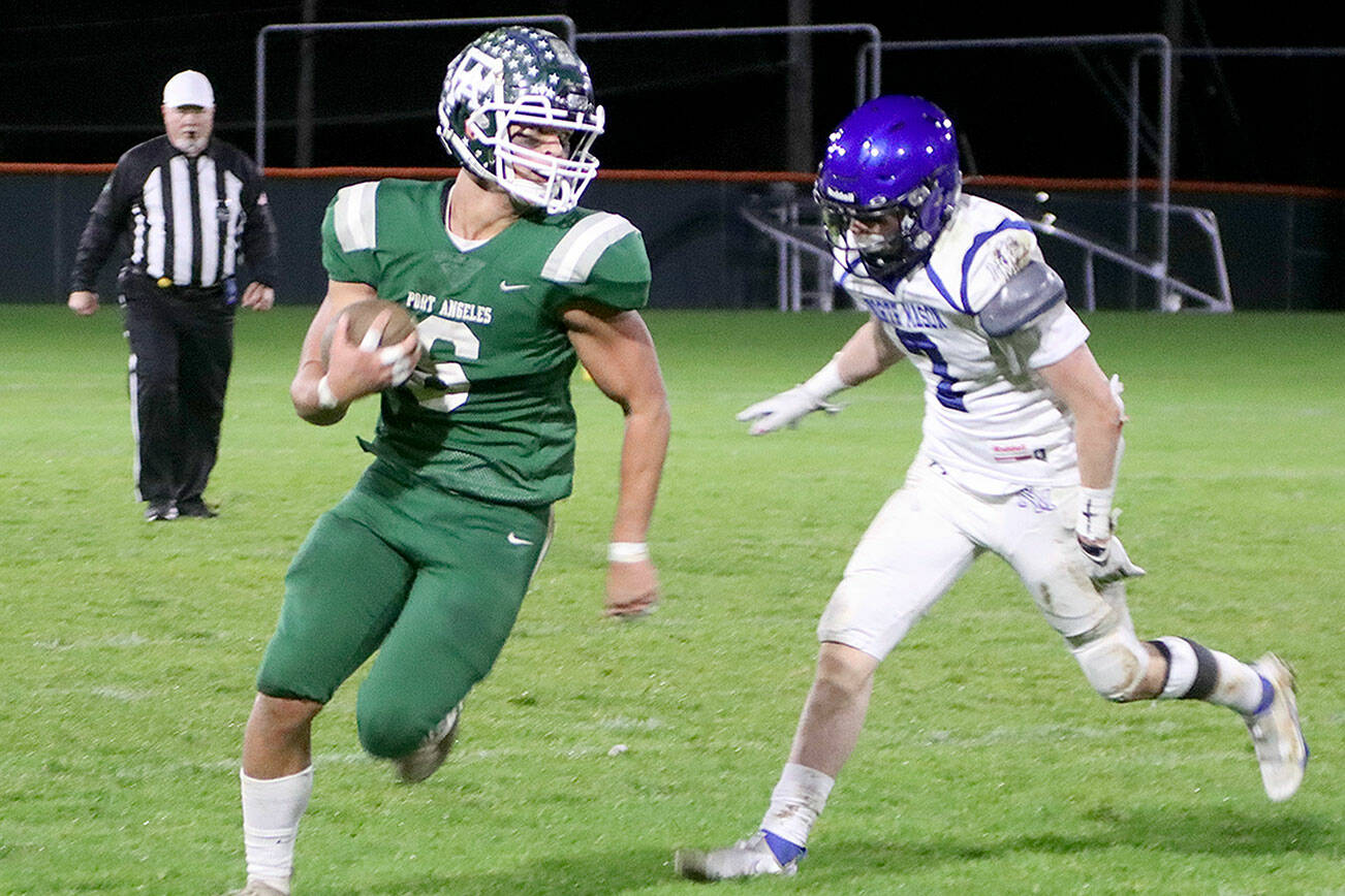 Port Angeles' Jaziel Livingston (6) outpaces North Mason Bulldog Dakota Filer (7) as he runs around right end for a good gain on the gridiron Friday at Civic Field. Livingston had 93 yards rushing and a touchdown in the 47-6 win. (Dave Logan/for Peninsula Daily News)