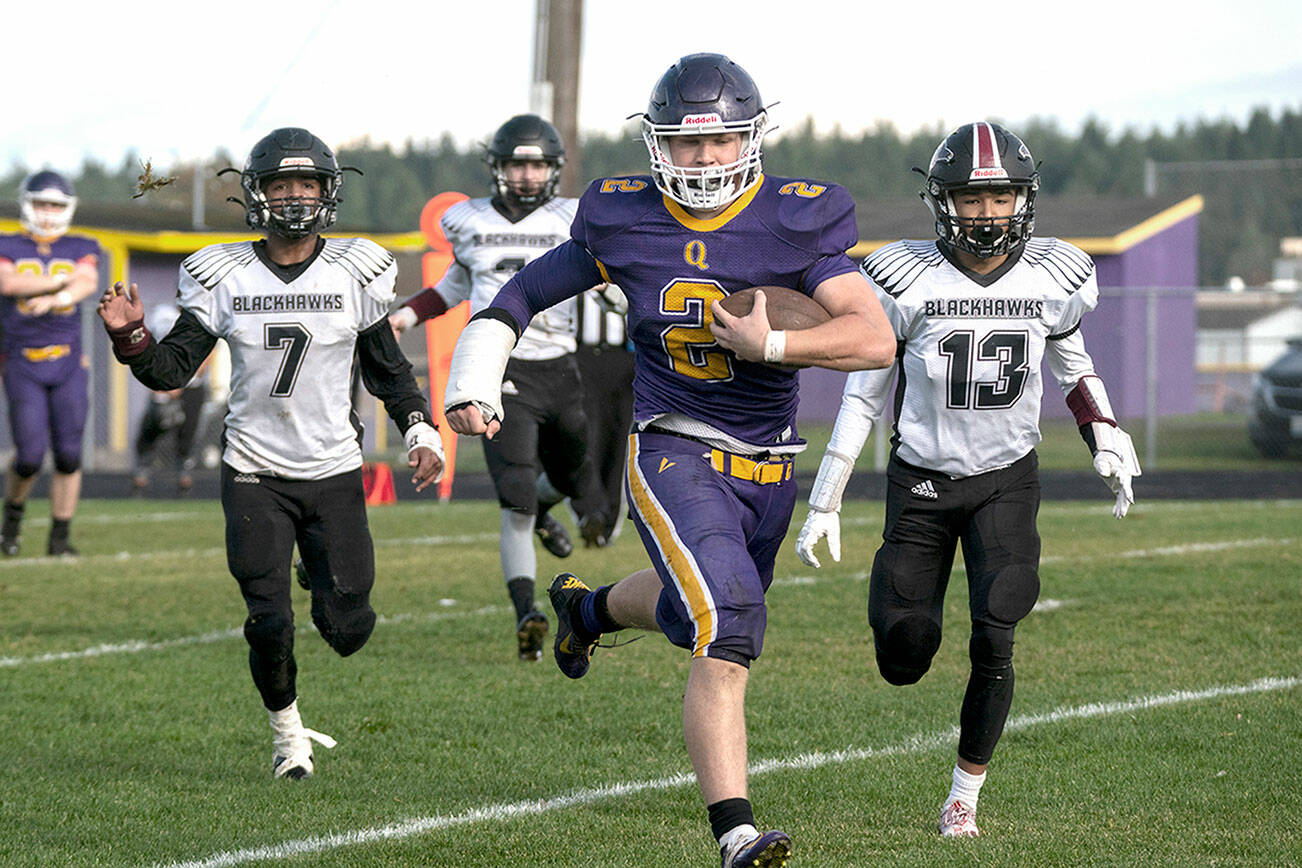The Quilcene Rangers’ Bishop Budnek runs unhindered to the goal line for a touchdown during a district playoff game against the Lummi Blackhawks. Budnek scored seven touchdowns on the day. (Steve Mullensky/for Peninsula Daily News)