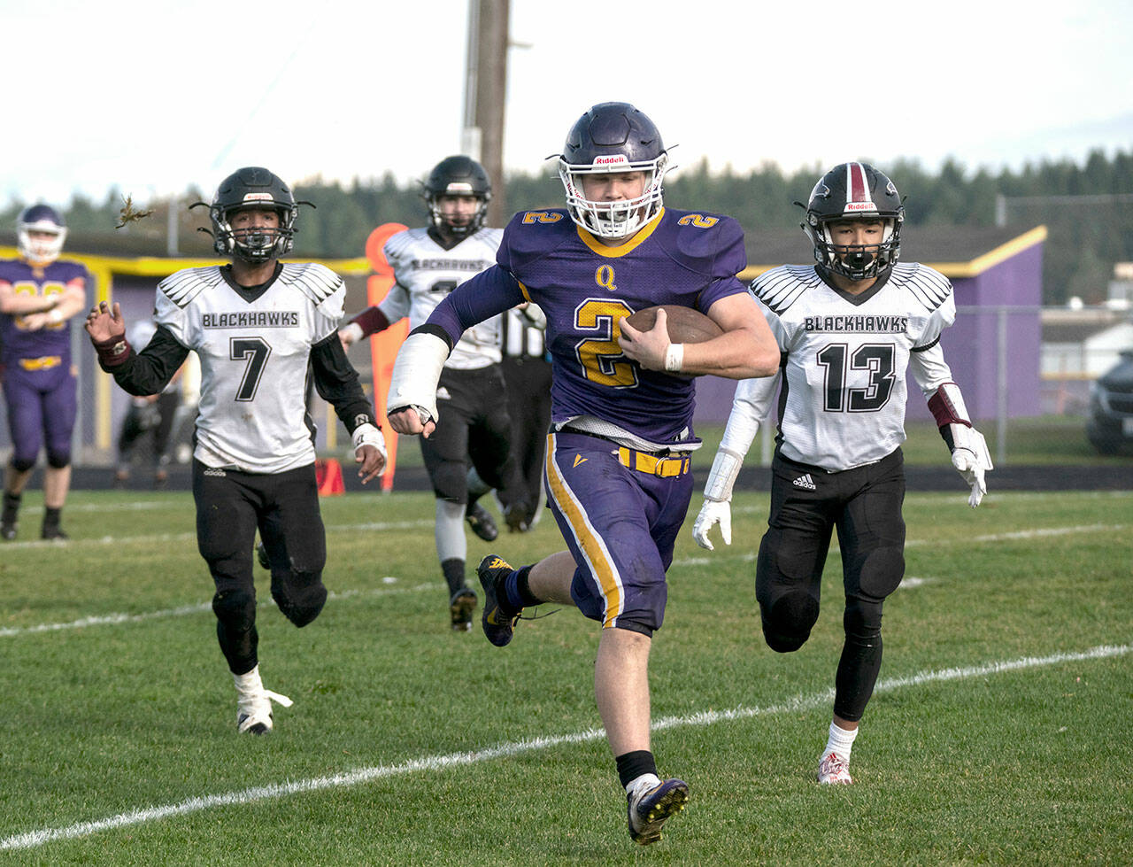The Quilcene Rangers’ Bishop Budnek runs unhindered to the goal line for a touchdown during a district playoff game against the Lummi Blackhawks. Budnek scored seven touchdowns on the day. (Steve Mullensky/for Peninsula Daily News)