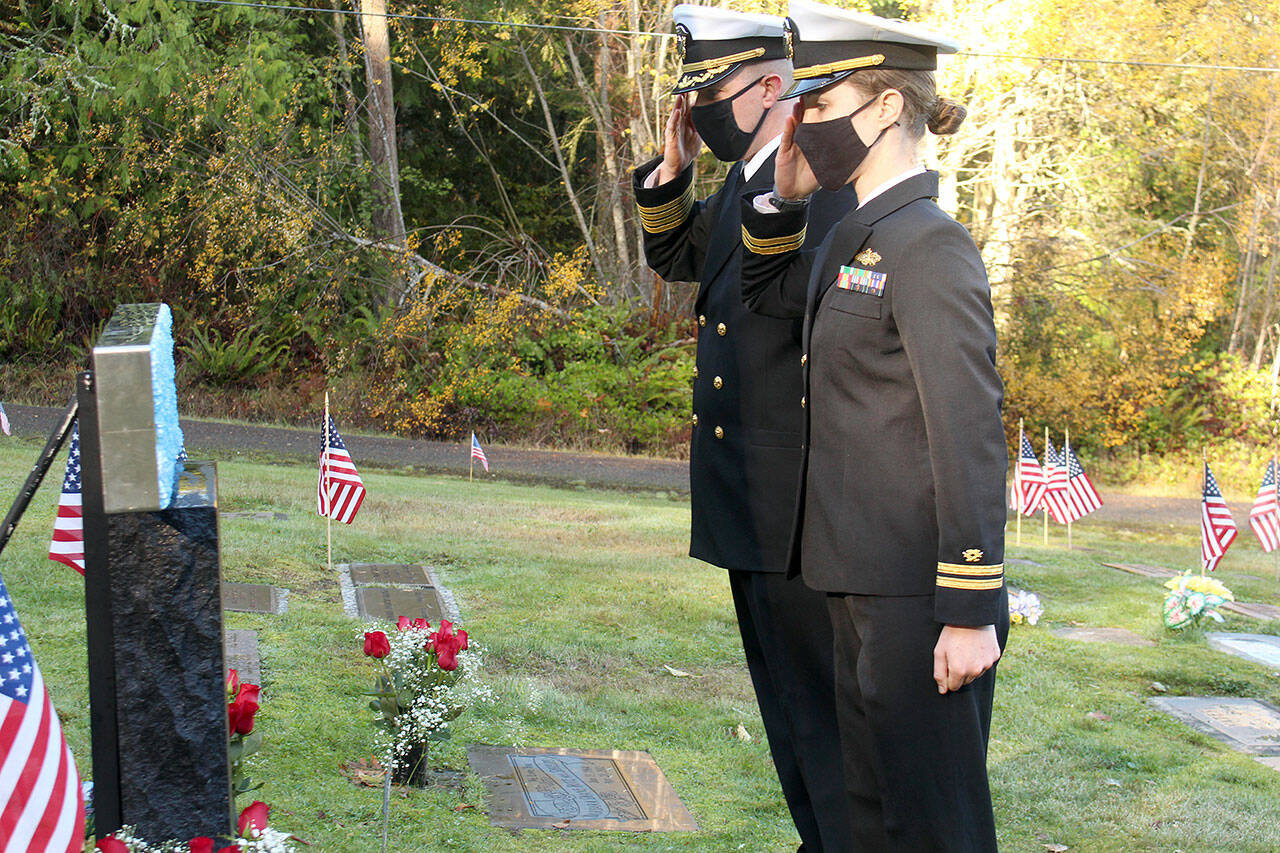 Naval Facilities Engineering Systems Command (NAVFAC) Northwest Commanding Officer Capt. Edward Miller, left, and Lt. Emily Wolff laid flowers on the grave of Construction Mechanic Third Class Petty Officer Marvin G. Shields during a Veterans Day ceremony conducted Wednesday morning at the Gardiner Cemetery. Shields is the only Navy Seabee to have received the Medal of Honor. (Zach Jablonski/Peninsula Daily News)