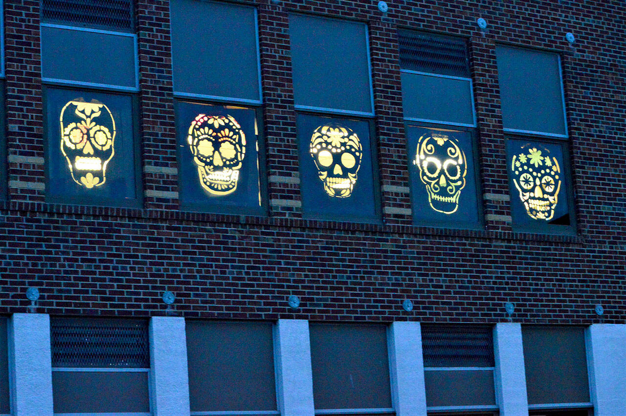 In honor of the Day of the Dead, Port Townsend High School students constructed decorations for the school's second-floor windows facing Benton Street. The students invite people to drive or walk past the windows as they're illuminated tonight and Monday night. (Diane Urbani de la Paz/Peninsula Daily News)