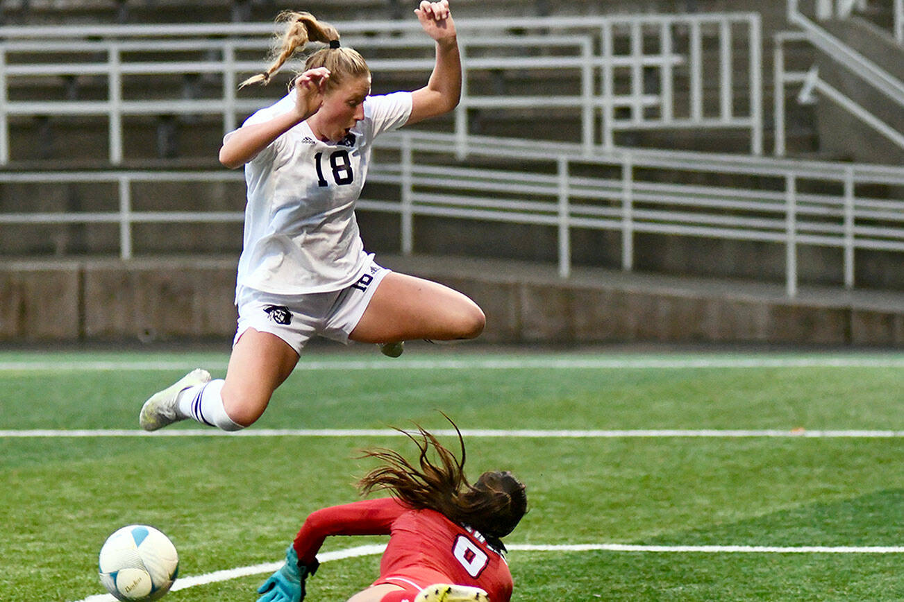 Jay Cline/for Peninsula College
Peninsula College's Kyrsten McGuffey hurdles Columbia Basin goalkeeper RiaJo Schwartz during the first half of the Pirates 2-1 come-from-behind win over the Hawks in the NWAC Semifinals on Friday at Starfire Sports Stadium.
