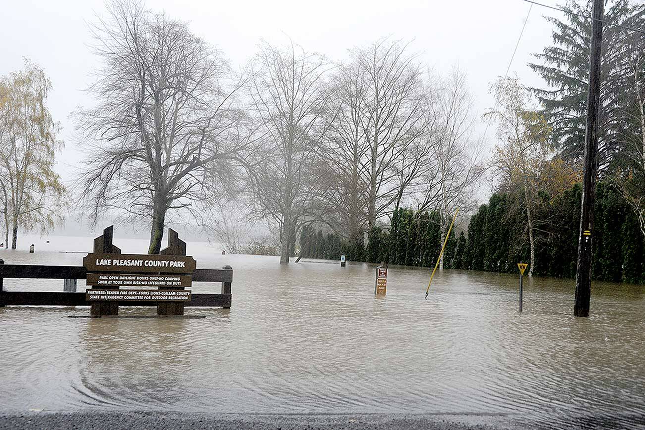 The waters of Lake Pleasant flooded the Lake Pleasant County Park on Monday. The water runs over the West Lake Pleasant Road and into neighboring homes. (Lonnie Archibald/for Peninsula Daily News)