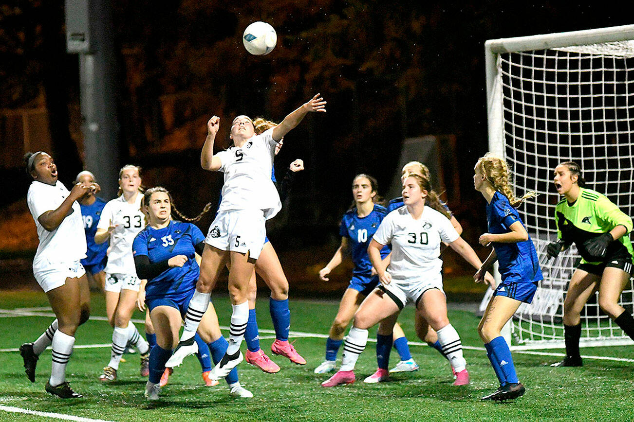 Peninsula College women battle for a ball in the box in front of the Clark goal in Sunday's NWAC soccer championship game. From left are Peninsula players Tommylia Dunbar, Cerese McMillian (33), Kascia Muscutt (5) and Addy Becker (30). (Jay Cline/Peninsula College)