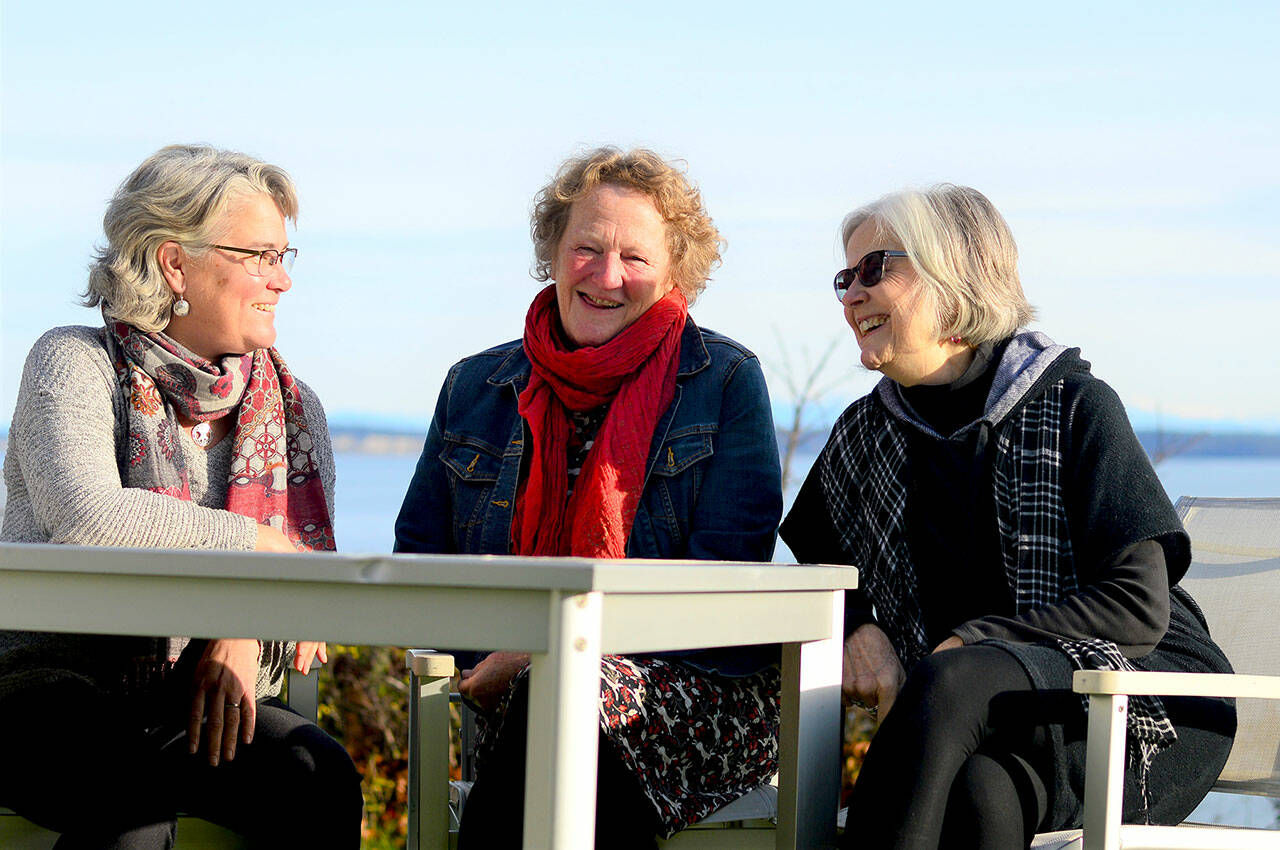 At the table where they first conceived their organization, Dying Matters Guild cofounders Carrie Andrews, left, Sarah Seltzer and Rhonda Hull talk about this weekend’s “Death, Grief and Ancestors” activities in Port Townsend. (Diane Urbani de la Paz/Peninsula Daily News)