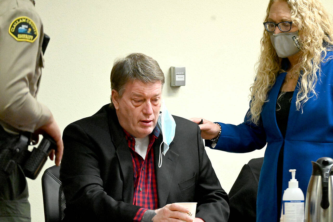 Accused triple-murderer Dennis Bauer reacts to the appearance of accused co-conspirator Ryan Ward in Clallam County Superior Court on Wednesday. (Paul Gottlieb/Peninsula Daily News)