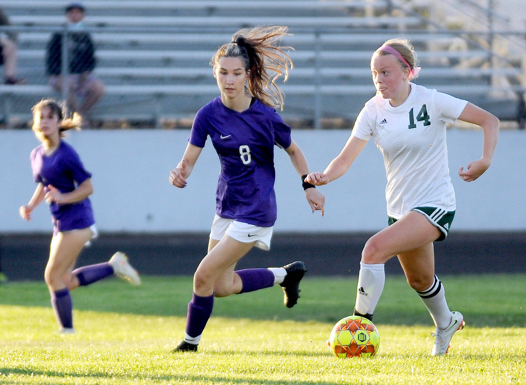Port Angeles Anna Petty (14) looks upfield as she dribbles against Sequims Zoe Moore. Petty, the Roughriders lockdown defensive central midfielder, is the All-Peninsula Girls Soccer MVP. (Michael Dashiell/Olympic Peninsula News Group)