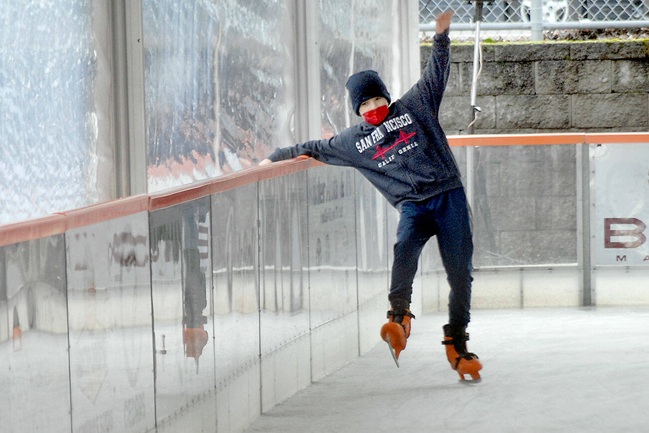 Joshua Wakefield, 11, of Sequim tries to keep his balance while learning the fine nuances of ice skating on Friday’s opening day of the Port Angeles Winter Ice Village in downtown Port Angeles. The village will be open for skating daily from 9 a.m. to 9 p.m. with breaks for ice resurfacing through Jan. 3. (Keith Thorpe/Peninsula Daily News)